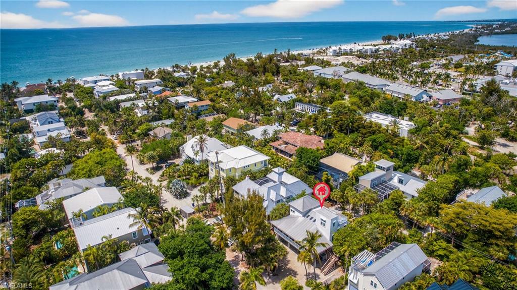 This near beach, 4 bedroom, 4 bath custom pool home is located on a sought-after private lane in Captiva's "Village". Just steps from the sugar sand, shell strewn beaches of the Gulf. Built and owned by one family who used it for many wonderful years and also as a great rental property. Fantastic floor plan with vaulted ceilings, sky lights, tile and wood floors throughout. The first floor offers a screen enclosed porch/lanai, living/dining combination with a breakfast sitting area next to the breakfast bar and kitchen. There is a primary suite with sliders that open to the balcony, bathroom with double sinks and a tub/shower combination. There is a guest bedroom and guest bath on this floor as well. Balconies and sliders that run around the perimeter of the house and overlook the screen enclosed pool. The 2nd floor has a spacious loft that opens to the lower level, a laundry room and offers 2 Bedroom En-suites. The 3rd floor has a private sundeck to watch wildlife, enjoy sunning and gazing at the stars at night. The screen-enclosed, heated pool is elongated to allow for lap swimming with plenty of space to sun and a covered outdoor area to enjoy outdoor dining, grilling and entertaining family and friends. Rinse off in the outdoor shower after a day at the beach. Just steps away from island restaurants, shopping, Marina, library and Chapel By the Sea. Buyer must honor rentals.