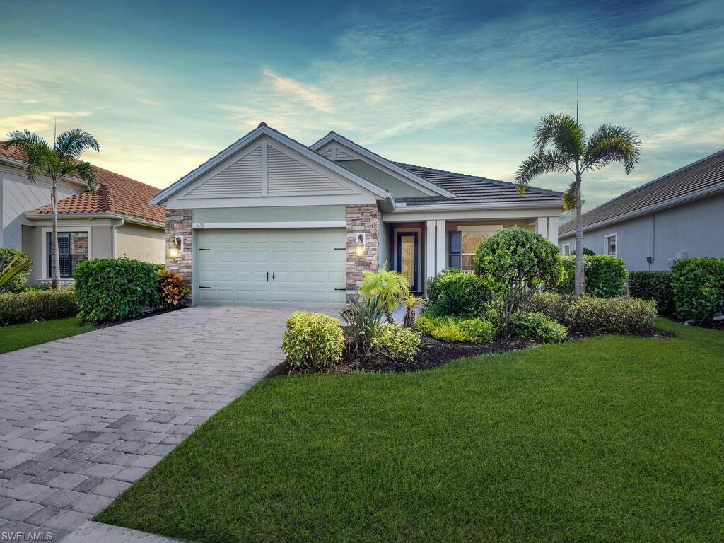 Welcome to the modern Key West style “Starlight” model, 3 bed, 2 1/2 bath home. Enjoy the long lake view from this open floor plan home. The covered lanai with electric storm shutters lead to the screened patio with the pool and waterfall feature. The open concept living room features coffered ceilings with recessed lighting. Enjoy the large kitchen island, with quartz counters and cabinets accented with neutral stone backsplash. The dining room has an abundance of natural light and lake views. The entire home makes for easy entertaining with the triple sliding door completely opened, allowing the indoor space to flow seamlessly to the outdoors. The master bedroom includes two large walk-in closets, a double vanity private bath with oversize walk-in shower. A double French door leads to the spacious den off of the entry foyer. This comfortable space to read or watch television can easily be repurposed to a fourth bedroom. The two car garage is improved with custom cabinet storage plus wall rack for bikes. Canopy is a gated community with 108 family homes with convenient access to I75 and major shopping and dining.  Located in top rated school district.