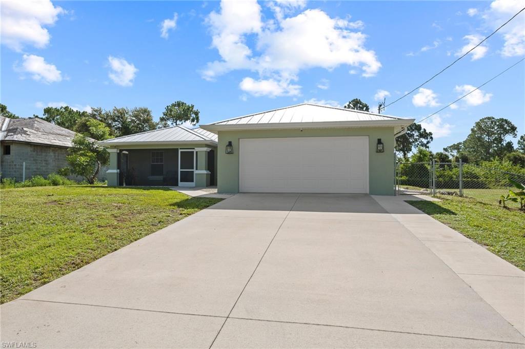 Nestled on a fully fenced half-acre at the end of a quiet dead-end street, this well-maintained home offers the perfect combination of privacy, comfort, and thoughtful updates. Major improvements include a **2024 metal roof**, **2024 A/C**, **2024 mini-split A/C** in the Florida room, and **spray insulation in the attic** for enhanced energy efficiency.

A screened front entry welcomes you inside to a spacious great room featuring soaring volume ceilings and attractive bamboo flooring. The generous kitchen is designed for both everyday living and entertaining, offering abundant cabinet and counter space, a stylish tile backsplash, pantry, and breakfast bar.

The split-bedroom floor plan features real bamboo flooring in all living areas, while the tiled wet areas and wood-look laminate in the great room, bathrooms, and Florida room provide durability and easy maintenance. The spacious primary suite includes a walk-in closet, walk-in shower, and French doors that open directly to the Florida room.

Flooded with natural light, the versatile Florida room boasts an abundance of windows, a beautiful wood ceiling, its own 2024 mini-split A/C, and access to the expansive fenced backyard. Whether you envision a home office, playroom, art studio, fitness room, homeschool space, or second living area, this flexible room adapts to your lifestyle.

Step outside and enjoy the privacy and endless possibilities of the fully fenced half-acre lot—ideal for pets, gardening, outdoor entertaining, or simply relaxing in your own backyard oasis.

Conveniently located with easy access to Fort Myers, Southwest Florida International Airport (RSW), Gulf Coast Town Center, The Forum, shopping, dining, entertainment, and major roadways, this home offers the perfect balance of peaceful country-style living and everyday convenience. With numerous recent updates, generous living spaces, and room to grow both inside and out, this move-in-ready property is one you won't want to miss.