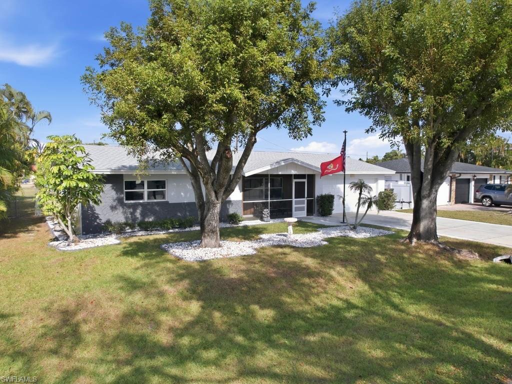 Welcome to this beautifully maintained and move-in ready 2-bedroom, 2-bath residence with a 2-car garage, located in a quiet and desirable neighborhood just off US-41 for an easy commute. This home offers peace of mind with a brand-new 2024 roof and impact windows throughout. A screened-in front porch and lush, well-manicured front yard landscaping create a welcoming first impression. The fenced backyard offers a great space for pets, play, or outdoor enjoyment. Step inside to a bright and comfortable living area featuring a custom built-in entertainment center and plenty of natural light. The kitchen has been updated with quartz countertops, refreshed cabinetry, and newer appliances, making it both functional and inviting. Both bathrooms have been updated and well maintained. Enjoy Florida living year-round on the screened lanai, perfect for morning coffee or evening relaxation. Ideally located just minutes from restaurants, shopping, and everyday conveniences, and only 25 minutes to RSW International Airport. This home is perfect for full-time living, seasonal residents, or an excellent investment opportunity.