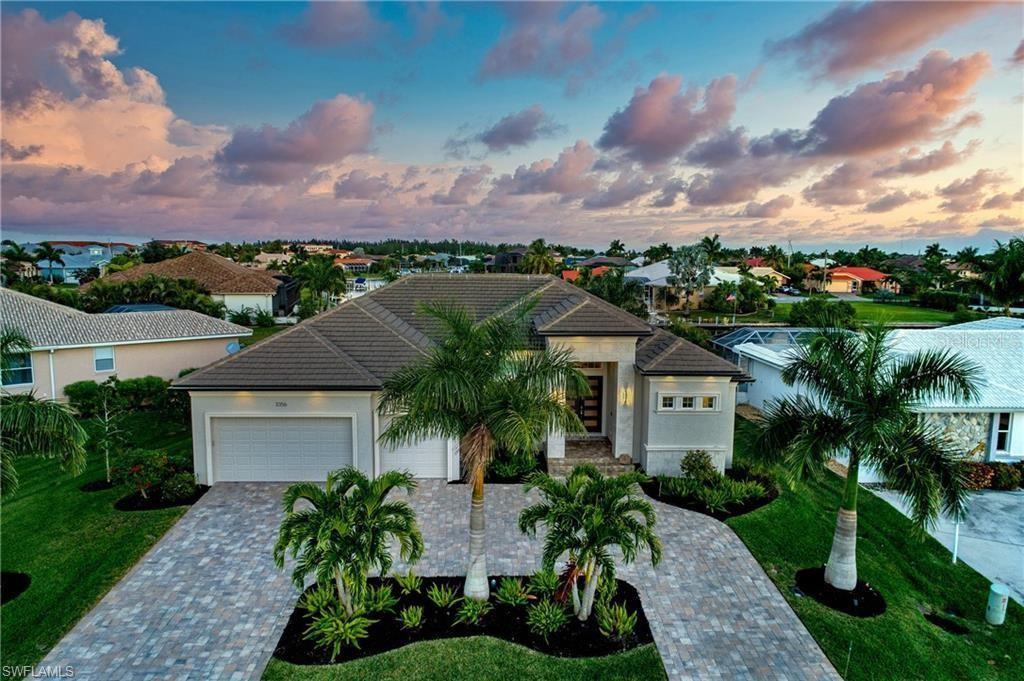 Why build when you can buy this custom pool home with upgrades & gulf access via deep water sailboat access canals? The great room with 14' coffered ceilings is connected to the gourmet kitchen and spacious exterior lanai with 8'zero-corner sliders. On one side is the Master suite with dual closets, separate shower & soaking tub, dual vanities, an oversized bedroom with trayed ceilings and private slider access to the lanai. Off the living room find a large den with built-in cabinets. The kitchen has custom cabinetry, a walk-in pantry, upgraded appliances, stone counters with seating in the island and open to the dining room. The 2 guest bedrooms have their own bathrooms, large walk-in showers and beautiful finishes makeup the other side. Additionally, there is a 3 garage w/ workshop and additional storage with cabinetry and granite counters; plus 2 covered lanais; a heated pool with infinity edge w/connected spa & a picture window cage for unobstructed long water Eastern views; and a summer kitchen with a built-in grill and eating area. At the water is an additional paver patio, concrete dock & seawall. This home is the perfect Southwest Florida dream! FEATURES SHEET AVAILABLE!