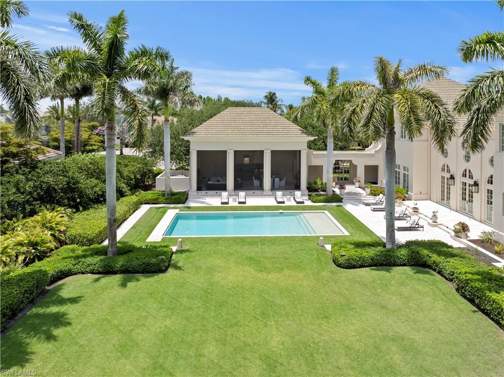 Poised in the desired community of Quail West, this extraordinary estate presents six bedrooms, seven full and two half baths spanning 6,814 square feet of refined living space. This remarkable bespoke home is fit for capture by Architectural Digest. Designed with timeless sophistication and built as a family retreat, the residence boasts soaring ceilings, abundant natural light, exquisite millwork, an oversized great room and a dream kitchen with marble finishes, professional-grade appliances and a butler's pantry. Thoughtful accommodations include dedicated kids bunk suites, a nearby playroom, additional bedrooms with en suites for parents, an exercise room and a luxurious primary suite overlooking the manicured grounds. Ideal for entertaining, the outdoor oasis features a resort-style saltwater pool, screened pavilion for dining and lounging, a pool bath and expansive front and rear lawns. On an oversized corner lot, this remarkable residence boasts a TRANSFERABLE GOLF MEMBERSHIP, complemented by world-class amenities, including tennis, pickleball, bocce, fine dining, a full-service salon and spa, a fitness center and a grand clubhouse. Pictures do not do justice to this home, it is must-see.