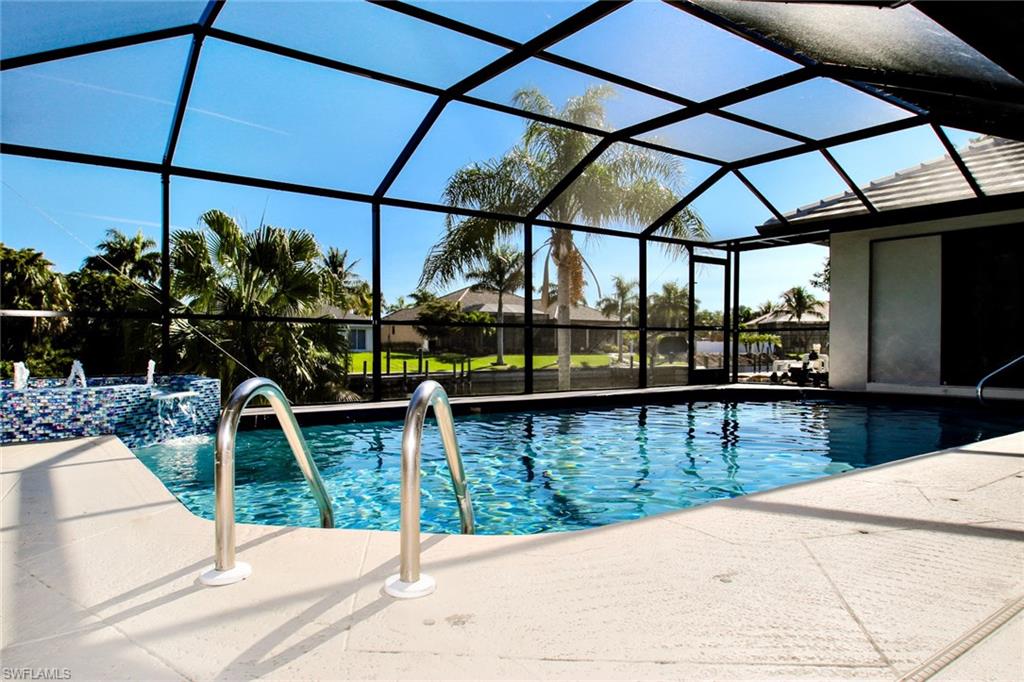 Triple Gulf Access home site -125' a 150' wide canal with a Stunning Home ready for your enjoyment. So much style greets you as you enter double stained glass doors. Work from home in a large den/office with plenty of storage space. Special touches include Lots of windows/ light throughout, Crown molding & plantation window coverings to showcase the style of this home in every room. A  stunning kitchen, SS appliances -granite counters, over-sized breakfast bar/built in cabinets around the eat-in kitchen. The great room features volume ceilings & sliding glass doors to the sparkling waterfall pool & mansard screen enclosure. Plenty of patio/lanai space too. Walk-in closets, master suite has very large walk-in closet. Enjoy specially designed baths- custom tile design, the largest bath features soaker tub & decorator tile shower. Tile floors throughout, inside laundry/granite sink & a pool bath. New 30 year slate multi-dimensional roof, oversized side load garage/ extra parking on the side for your boat & other toys. Easy access to the Gulf of Mexico-located in the Cape Harbour SW neighborhood with waterfront dining, shopping & entertainment, side walk/bike path neighborhood.