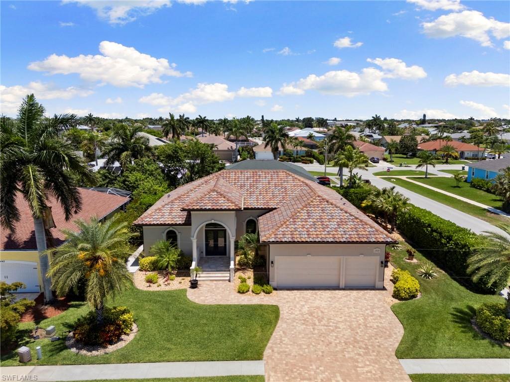 Welcome to this beautifully crafted 3 bedroom, 3 bathroom, 3 car garage custom built home in the heart of Marco Island. Situated in a highly desirable neighborhood, this thoughtfully crafted paradise seamlessly blends structural integrity with elegant design. High, soaring ceilings and textured travertine-style tile flooring run throughout the entire home, creating an open, airy, and pleasant atmosphere. A true centerpiece of the home, the sparkling kitchen features a large center island, beautiful granite countertops, a dedicated pantry, and premium finishes perfect for culinary enthusiasts. This floor plan provides a sensational open concept, which includes a delightful great room with ample space and a comfortable dining area that will impress. Double french doors lead you to an oversized primary suite that includes access to the pool area and a primary suite bath that features double vanities, a walk-in closet, a separate water closet, and a spacious walk-in shower. The full cabana bath adjacent to the pool features a pristine walk-in shower, and the third guest bath boasts double vanities with a tub/shower combo. A luxurious 3-car garage offers space for multiple vehicles, water sports equipment, beach gear, and built-in shelving for additional storage, all leading out to a lovely paver driveway. Step outside to the expansive, beautifully paved stone lanai surrounded by lush, natural privacy landscaping. Relax by the pristine pool, utilize the convenient outdoor shower, or unwind in the tranquil dedicated side sitting area, adjacent to the screened lanai, perfect for maximizing the fun in the Island sunshine. The thoughtful split-bedroom floor plan offers ultimate privacy, including a fantastic bedroom abutting the pool with its own en-suite bath. Laundry is a breeze with a sizable room with a washer, dryer, sink, and plenty of cabinet storage space. Enjoy ultimate peace of mind with impact-rated windows and sliders throughout the home. AC replaced 2026, smoke detectors replaced 2026 as well. Most furniture staying, see inventory for details. The home is a remarkably short distance to beloved Mackle Park and is also very close to the library, museum, shops, and restaurants. This may well be the home you have been waiting for; check it out and experience what this paradise has to offer.