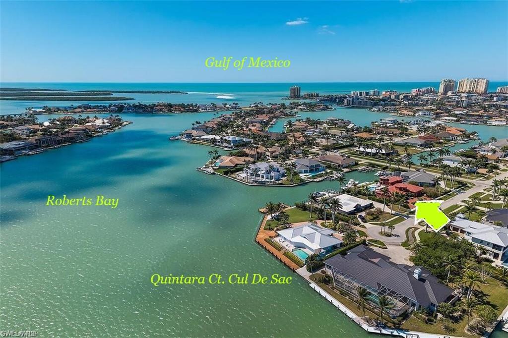 Marco Island Estate Area located off Roberts Bay. YACHT FRIENDLY. DIRECT ACCESS WATERFRONT HOME in SOUGHT AFTER SOUTHERN EXPOSURE 125' of Waterfront. 80' BELLINGHAM CONCRETE floating dock with Ramp. Custom-built home nestled on a private cul-de-sac one of only 8 homes. Quick deep-water access to the Gulf via Caxambas Pass. This property is a boater's dream. Positioned on .43 acres, this residence offers exceptional outdoor living, expansive water views and resort-style amenities. A Propane-heated Saltwater Pool & Spa, make this the ultimate retreat for everyone! With 5,895 sq. ft. under air, 4 Bedrooms lower level, 2 bonus rooms upper level,3 Full + 2 Half Baths. EXPANSIVE LOWER POOL DECK (2,850+ sq. ft.) PLUS EXPANSIVE TILED UPPER DECK ( 1090 sq. ft.) w/ROBERTS BAY VIEWS. Library with custom wood cabinetry, indoor dual gas fireplace, chef's kitchen with Viking Gas Stove, Sub-Zero, and Bosch appliances, plus 2 wet bars. Fully equipped Viking appliances OUTDOOR KITCHEN. Imported mahogany doors, imported 3/4 " Jatoba hardwood floors. IMPACT DOORS and WINDOWS, SLIDERS throughout, 5-ZONE A/C Whole-house water filtration. Central vacuum. Central Alarm w/cameras, SONOS sound system, epoxy-coated 3-car garage.Lush mature native landscaping.Fenced side yards for privacy. Located about 1 Nautical mile to Caxambas Park Fuel Dock and CAXAMBAS INLET. Stroll or Bike about 1.25 miles to Winterberry BEACH ACCESS.This rare offering delivers the perfect blend of tranquility with panoramic wide-water views and unmatched location in the heart of Marco Island.