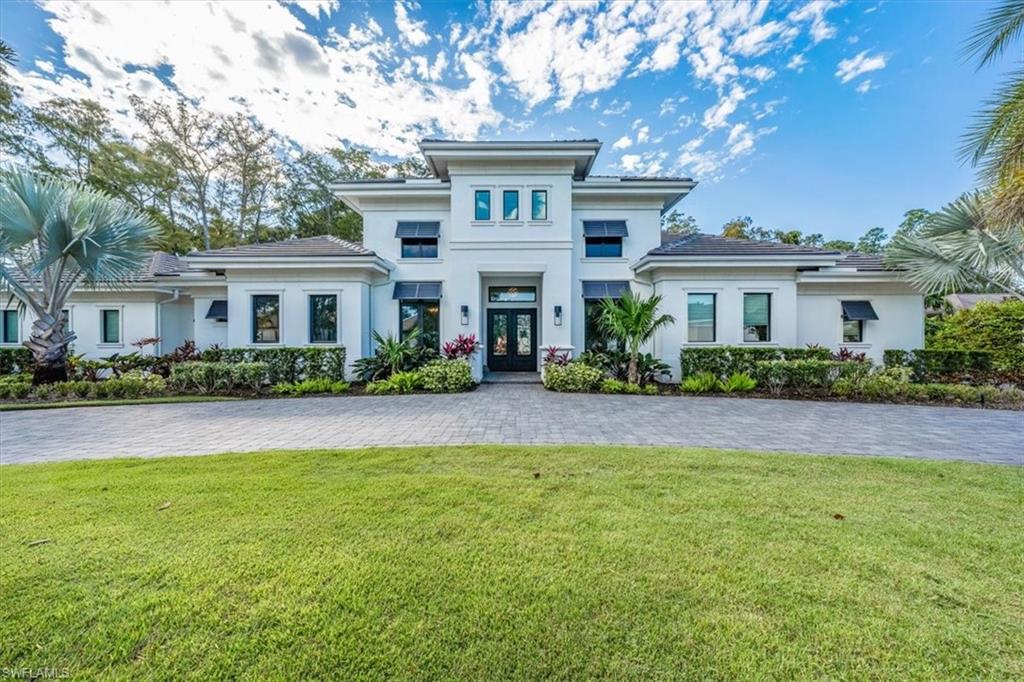 H12437 An unparalleled living experience awaits as you enter this impressive custom-built home offering synergistic indoor-outdoor living compliments of a wall of pocketed glass doors. Enriched w designer details throughout & situated on nearly an acre w 200’ of frontage, this home captivates.The welcoming lanai w saltwater pool & waterfall spa presents over 1800sf of enjoyment incl a covered area for relaxing & dining, electric fp & fully plumbed area for your own outdoor kitchen. Practically transparent, the panoramic cage screen merges the beauty of the lush landscaping & spacious green areas to make this private paradise an escape w tranquil views devoid of intrusive elements. The indoor open concept combines living rm, kitchen & dining room to create a harmonious center while the well-appointed kitchen made for entertaining boasts a spacious island, finely crafted cabinetry & hidden walk-in pantry.The large primary ste is an oasis w high ceilings, custom blt-ins, his/hers closets, spacious bath w double vanities, freestanding tub & oversized walk-in shower. The split floor plan offers privacy & 4-car garage (2/2’s) w/storage furthers the fusion of tranquility and practicality.