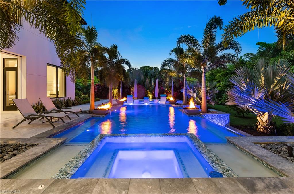 BEST VALUE IN PINE RIDGE ESTATES: Experience privacy at its finest in this stunning custom home located in the prestigious Pine Ridge Estates. Impeccably furnished by Clive Daniel Design, this gated and fenced residence offers the utmost security and smart home technology. Step inside and be greeted by the exquisite craftsmanship and high-end finishes throughout. The gourmet kitchen and full butler's pantry are a chef's dream, while the two laundry rooms provide convenience and functionality. With 12-foot ceilings on the main level and 10-foot ceilings on the upper level,(Elevator), this home boasts a spacious and airy ambiance. Indulge in the luxury of two master suites, one on each level. The main floor master suite features his and her custom-designed closets, a steam shower, a separate tub, and a smart commode. Each bedroom in this home is a suite, complete with a full bathroom, king-sized bed accommodation, and walk-in closets. Take in the breathtaking views from the two balconies on the upper level. This home is equipped with a range of desirable features, including central vacuum, Lutron shading throughout, custom drapery, and smart home technology. The property is connected to city water, with irrigation sourced from a well. Entertain with ease in the backyard oasis, featuring a salt-water pool and spa with color lighting, a screened lanai with a built-in grill and pizza oven, and more.No detail has been spared in this home, with 4 Miele dishwashers, 3 ice-makers, several beverage coolers and drawers, and a large wine room. The extensive landscaping and lighting create a picturesque setting, and the property even includes a generator for peace of mind.Situated on over an acre lot, there is ample space to accommodate a guest house, with plans already prepared. Don't miss the opportunity to own this exceptional property that offers both luxury and privacy. North and South garage can each hold 4 cars with a lift system. X-500 Flood zone. Need a family compound? **The house next door is also for sale (rare opportunity) remove the middle fence and have family generational living.**