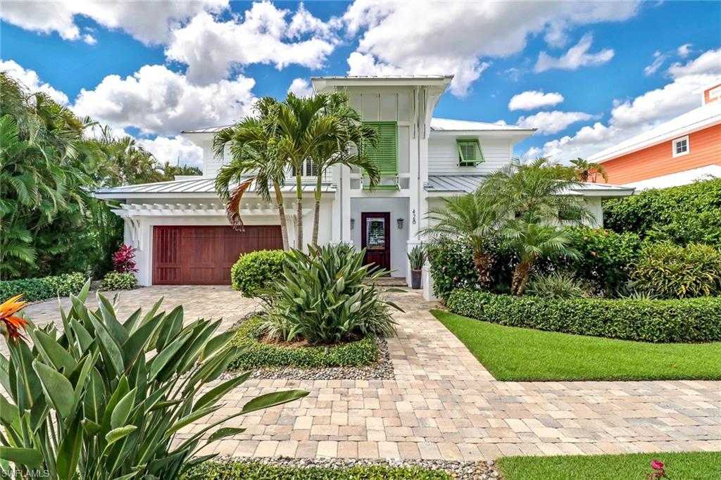 SOUTHERN EXPOSURE POOL HOME IN OLDE NAPLES, 3 BLOCKS TO THE BEACH ! Why spend more on new construction when this home beats everything else out there at a better price? All the final touches of an inviting décor have already been included! This Old Naples seaside-styled home is the best ending imaginable to your own fairytale of living in Paradise! Meticulously constructed home was designed by MHK Architecture. Soaring ceilings in the great room, fireplace for mellow nights, built-ins and bar. This amazing cook’s kitchen w/ island & high-end appliances opens to dining and lounge space. A tranquil 1st floor owner’s suite with private access to lanai, separate owners’ closets, and spa-like en-suite bath. Upstairs one can enjoy two impeccably designed guest suites, en-suite baths, ample closets, and morning bar. Office space is highlighted w/ built-ins and sliding barn doors to provide privacy. Masterfully crafted outside space with lush gardens, front porch, and decking space. Enjoy the pool/spa with LED lighting, waterfall wall, trellised area for dining. Great storage in the beautifully finished garage. Widened driveway and extra on street parking right in front of the home!