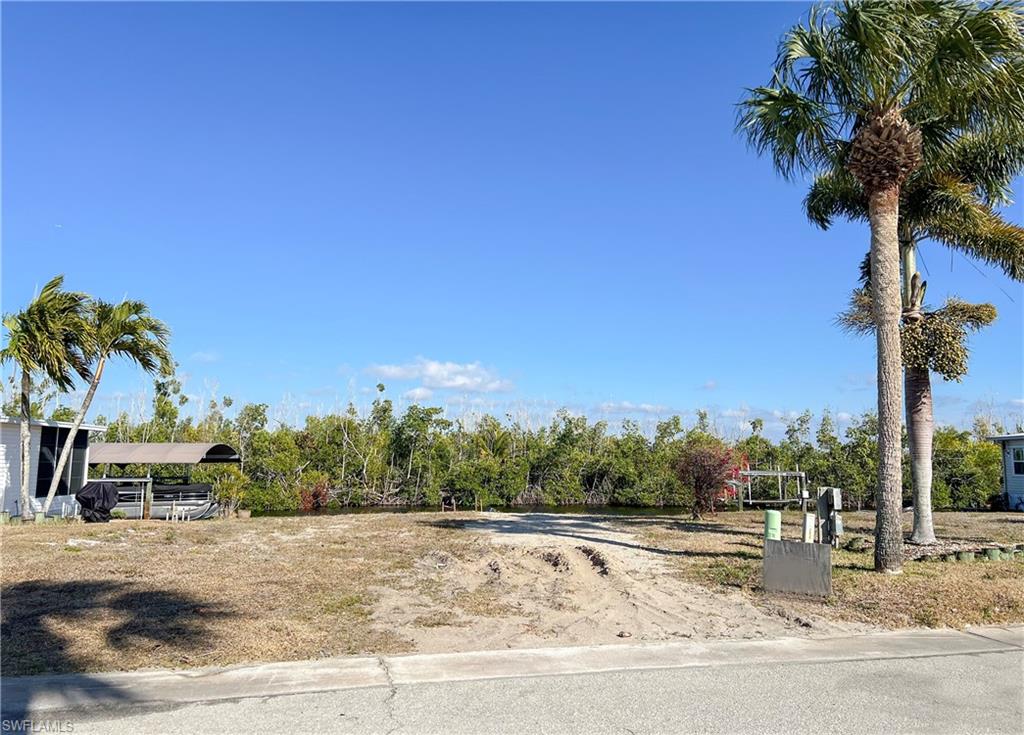 Relax and take in the beautiful open water canal and preserve views from your canal-front property. With access to the Gulf and beaches just minutes away, this is your chance to own a piece of paradise! This cleared lot is perfect setting for your new home. East facing provides glorious morning sunshine and shaded afternoons to relax outdoors. Bayside Estates is a vibrant 55+ manufactured home community, offering a laid-back lifestyle and a welcoming atmosphere. Buyers in Bayside Estates pay a one-time $2,800 resale capital contribution fee. This highly sought-after community is ideally located near beautiful FMB and Sanibel beaches, great dining, and a variety of local attractions. Don’t miss out—this is the ultimate boating life opportunity!