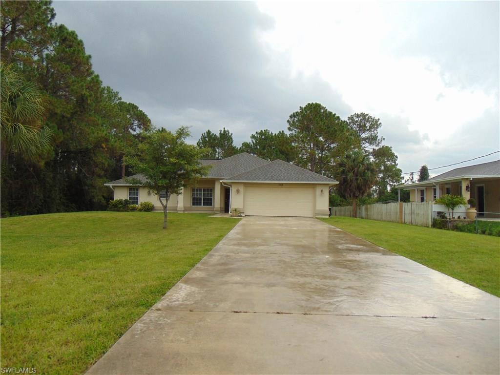 Located in one of the most prized enclaves of Lehigh Acres, where shade trees abound and most homes are perfectly situated on half acre parcels, this conveniently located 4 bedroom / 2 bathroom+ 2 car garage, single family home is a real MUST SEE! A true 4 bedroom gem, 2 of the guest bedrooms feature their own walk-in-closets. The 3rd bedroom is spacious too & the split floor plan offers a private master bedroom retreat that boasts 2 walk-ins & an ensuite bathroom with walk-in shower. You will LOVE the beautiful interior - cathedral ceilings in the main living space make the nearly 1700 square feet of A/C living seem even larger. Stainless steel appliances are an attractive touch. New flooring, new paint (Int & Ext) are in the works & the social bathroom tub/shower is brand new. The open back porch is large and completely under truss. Lawn irrigation is in place and there's plenty of room for a pool on the 1/2 acre parcel of land. Septic pumped within the last year and recently treated. Call today to set up a private showing appointment! More photos coming soon. Agents read remarks.