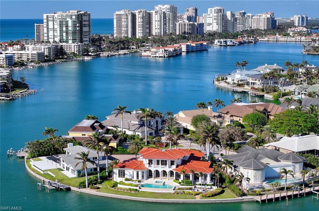 NOT LIKE ANY OTHER HOUSE ON THE STREET, MIAMI VICE INSPIRED THIS CUSTOM BUILT HOME BY KURTZ HOMES IS DESIGNED FOR THE LARGE FAMILY OR BUYER WHO LIKES TO HAVE OVERNIGHT GUESTS AND ENTERTAIN.  HIGH AND DRY NO WATER DAMAGE FROM RECENT HURRICANES. ENTER INTO A LARGE GREAT ROOM WITH DINING ABILITIES, GLEAMING MARBLE FLOORS, FIREPLACE AND A WALL OF FRENCH DOORS LOOKING OUT TO THE BAY.  MASSIVE KITCHEN WITH COMMERCIAL GRADE APPLIANCES, COUNTER DINING, QUARTZ COUNTERTOPS, ALL FLOWING INTO A COMFORTABLE DEN.  BUTLERS PANTRY FOR EASE OF SERVING.  PRIMARY BEDROOM ON FIRST FLOOR WITH RECENTLY REMODLED BATH, SOAKING TUB, SEPARATE SHOWER DOUBLE SINKS, UPPER LEVEL SUITE ACCESSIBLE BY PRIVATE ELEVATOR HAS SO MUCH FLEXIBILITY IN- LAW SUITE NANNY HEADQUARTERS ETC.  LOACTED ON A PRIVATE QUIET CUL-DE-SAC STREET, YOU EXPERIENCE THE MOST MAGNIFICENT WIDE WATER VIEWS, CALM WATER AND 365 DAYS OF SUNSETS.  A SHORT BOATRIDE TO THE GULF ENHANCES THE VALUE OF THIS HOME. ANOTHER BONUS NO HOA FEES.    TAKE ADVANTAGE OF THE OWNER'S DECISION TO SELL THIS SHOW PIECE.