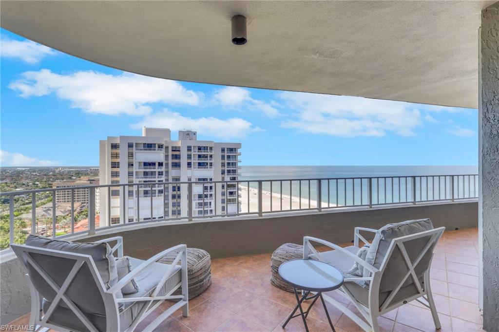 Wow what a show stopper this stunning unit is on the 21st floor of the Summit House on Marco island. Nothing but views from every room in the condo. Hurricane impact sliders and accordion shutters offer plenty of storm protection but wait until you see the inside. Updated kitchen with granite counters and travertine back splash, stainless steel appliances and a custom built-in pantry offering plenty of storage. Wood plank tile flooring throughout main living areas for easy maintenance. Very spacious custom dining area can sit up to 8 people comfortably and enhance that usually wasted space in other similar floor plans. Primary bedroom offers a King bed and crown molding and an updated bathroom with double vanity and a large walk-in shower with frameless glass doors and custom linen closet area. New washer and dryer in the unit and again more custom storage cabinets for all your laundry needs. From custom closet cabinets to built ins throughout, this unit is a must see. The views are spectacular and even the guest bedroom has gulf views. Enjoy Fourth of July fire work show with front row seats from your private large balcony. The Summit House of Marco Island offers one of the shortest and closest private boardwalks, with direct beach access which the residents love and enjoy, plus an exercise room, pool and spa, library and much more! what are you waiting for, make your move today!!!