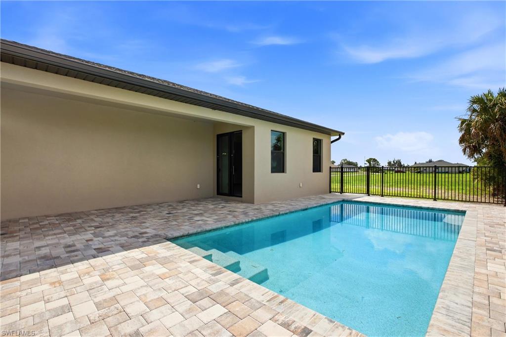 New 3/2 Pool Home for Rent on Canal, Fenced Yard, Pets Welcome. Your Dog Approves of This Backyard

BRAND NEW 3 bed, 2 bath, 2-car garage POOL home for rent on a canal in NE Cape Coral. Offering 1,515 sq ft of living space, a fully fenced yard, pool care included, and pets welcome with approval, a one-time pet fee, and no monthly pet rent. Available now.

This rental home didn't show up to compete. It showed up finished. Brand-new construction sitting right on a canal, with a paver driveway that sets the tone before you're even out of the car. No inherited decisions, no compromises, no work required on your end. Just move in.

Inside: crisp finishes, custom accent walls, recessed lighting, and oversized modern fans that make the living space feel upgraded, not staged. The kitchen isn't an afterthought. Waterfall countertops, high-end finishes, and a peninsula island with bar seating built for actual use.

Three spacious bedrooms. Two sharp bathrooms with lighted anti-fog mirrors that make mornings simpler instead of steamed over.

The backyard is where this one wins. Enjoy your own private pool and paver deck overlooking the canal, with a fully fenced yard that gives your pets plenty of room to run. Your dog will probably consider this yard their personal kingdom. Best of all, professional pool care is included, so you can enjoy the waterfront lifestyle without the maintenance.

No city water bill. The home is on a private well, and professional monthly well service is provided for your convenience, including salt replenishment and routine maintenance. A flat $65/month well service fee is billed with rent, so there's no need to schedule or manage the service yourself.

The epoxy-coated garage floor adds a clean, finished touch, and washer/dryer hookups are ready to go (tenant provides machines). Conveniently located near downtown Cape Coral, you'll be close to restaurants, shopping, parks, and everyday essentials.

Pets are welcome with approval. A one-time pet fee applies, with a minimum fee of $350 per pet, plus a $25 pet acceptance fee per pet. No monthly pet rent. Breed restrictions apply. 

Lease Terms: Available now. 12-month lease. Security deposit of $2,799 and application fee of $75 per adult apply. $45/month Resident Benefit Package fee. $65/month well service fee. Pool care is included. Tenant provides washer and dryer.