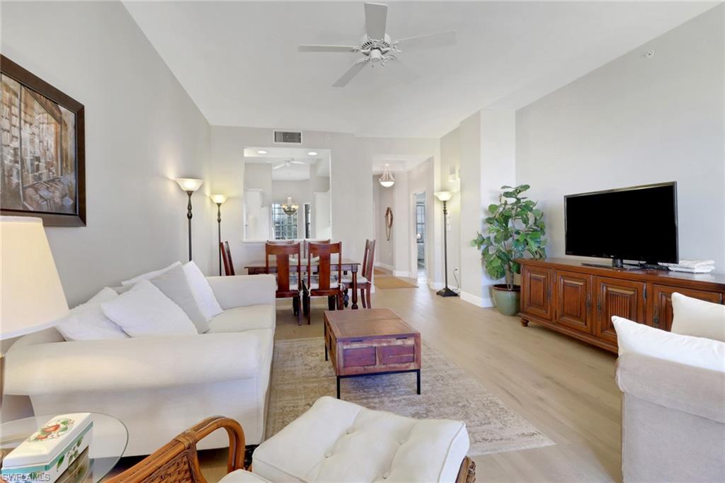 Welcome to effortless Naples living in this beautifully appointed top-floor residence at Bayfront. Filled with natural light, this spacious two-bedroom, two-bath condominium features a desirable split-bedroom layout, soaring volume ceilings, and an open-concept design that creates an inviting sense of space and flow. Thoughtfully designed with refined finishes, abundant storage, and a private lanai overlooking spectacular sunset views, this home offers the perfect balance of comfort and sophistication. Beyond your front door, you'll enjoy an exceptional collection of resort-style amenities, including two sparkling swimming pools, tennis and pickleball courts, a fully equipped fitness center, and a vibrant clubhouse designed for socializing and relaxation. Perfectly positioned in the heart of Naples, Bayfront places you just minutes from the boutiques and award-winning restaurants of 5th Avenue South, the scenic trails of Baker Park and the Gordon River Greenway, and the world-famous white sand beaches along the Gulf. Whether you're searching for a full-time residence, seasonal retreat, or investment opportunity, this exceptional home offers the very best of the Naples lifestyle; where convenience, luxury, and coastal living come together.