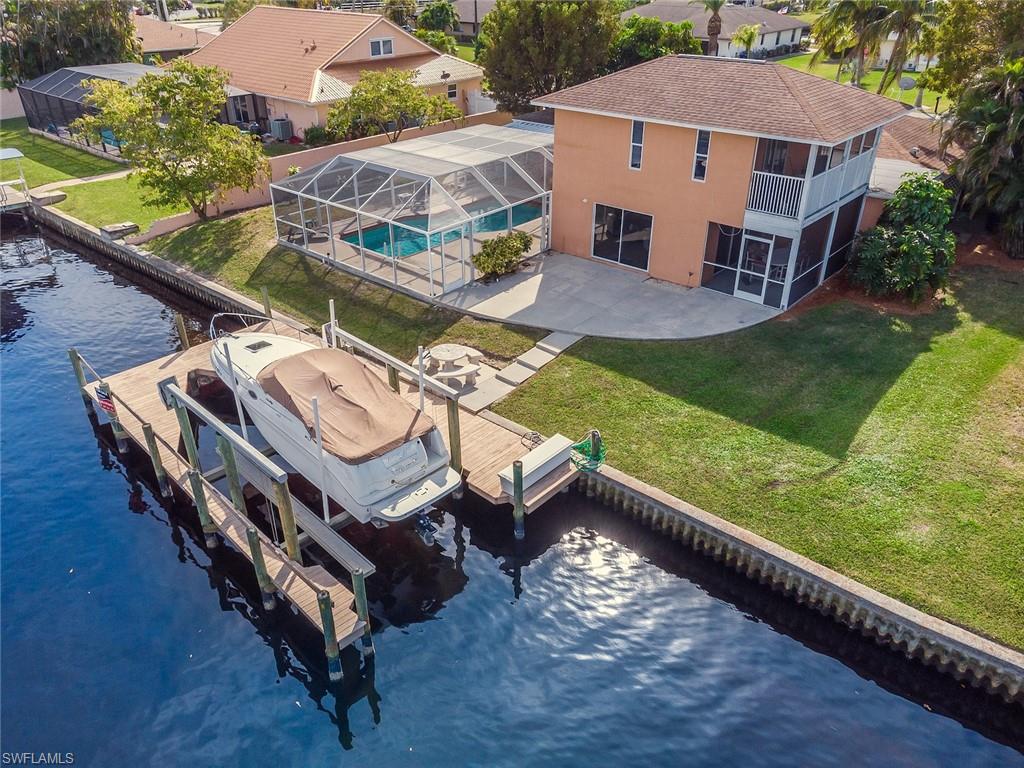 Amazing coastal living! Situated just minutes from the Gulf of Mexico and offering a boater's dream home w/ boat dock equipped w/ lift on a DEEP WATER canal. This single family pool home offers a fantastic layout for growing family w/ living & family room design, formal dining area & breakfast bar, open concept kitchen, split bedroom floor plan, spacious master suite w/ walk-in closet on first floor, screened lanai off of family room, guest suite (w/ full bath, walk-in closet, & screened lanai) on second floor, 2-car garage, and wonderful outdoor living space of a screened pool lanai & a large open lanai. Deep Lagoon Estates is a non-gated community w/ no HOA fees & has easy access to both Fort Myers Beach and Sanibel/Captiva Island.