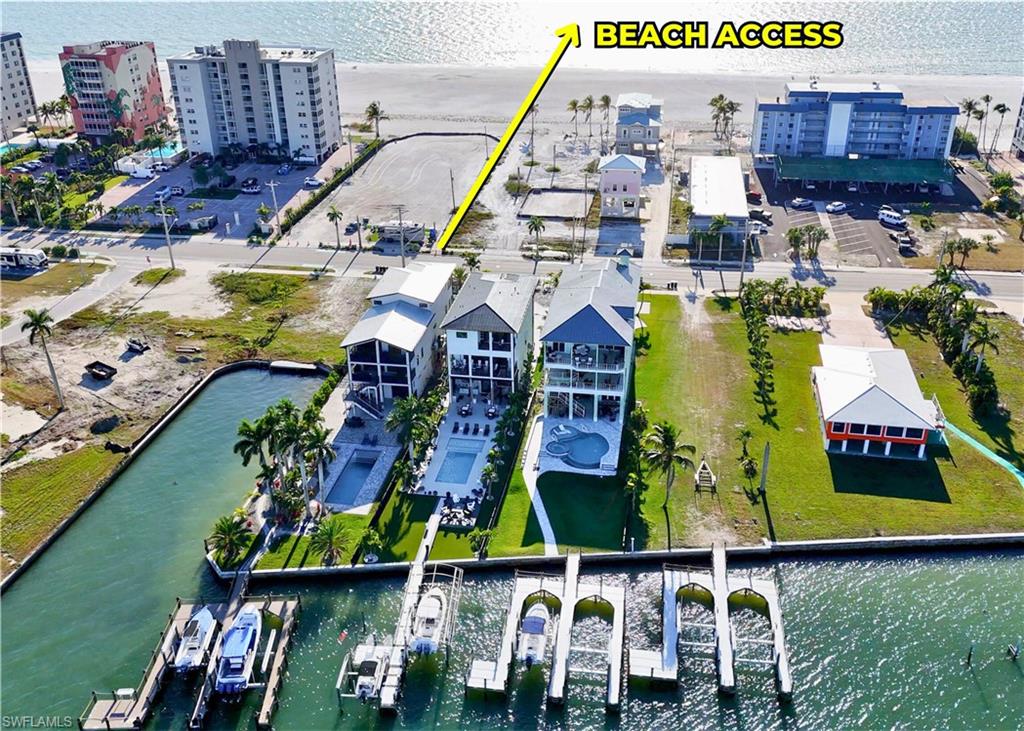 A striking fusion of modern architecture, refined craftsmanship, and coastal living, 441 stands as one of Fort Myers Beach’s most exceptional north-end waterfront residences. Located just moments from Times Square with quick access to the Matanzas Pass Bridge, this premier address offers the perfect balance of convenience, privacy, and postcard-worthy surroundings. With the Bay in your backyard just minutes to open water and the beach in your front yard, the lifestyle here is nothing short of extraordinary.

Bold curb appeal sets the tone with a wide paver driveway, abundant exterior lighting, and commanding modern lines that create a powerful first impression. Inside, the home’s elevated design showcases full concrete walls and concrete floors throughout, custom plantation shutters, two laundry rooms, and an expansive enclosed lower level in addition to two garages. Architectural resin pecky cypress ceilings, monolithic quartzite slabs, Lauriermax cabinetry, and a curated LED lighting design enrich every room with luxurious texture and ambiance.

The gourmet kitchen is both sculptural and functional, featuring a Wolf 6-burner natural gas range, Sub-Zero refrigeration, a hidden walk-in pantry, quartzite surfaces, an integrated barista system, and instant hot water on demand at the kitchen sink. The adjoining bar area is perfectly designed for elevated entertaining with a full-size wine refrigerator, fridge and freezer drawer, and an under-counter ice maker. Floor-to-ceiling glass fills the home with natural light and frames expansive Bay views, complemented by a sleek interior gas fireplace.

Each bedroom offers a private balcony and spa-inspired bathrooms with custom cabinetry and quartzite finishes, while the owner’s suite adds serene water views, a hydrotherapy tub, and a custom wardrobe. Outdoors, the home becomes a private waterfront resort with an alfresco culinary area featuring roll-down screens, a custom pool with underwater seating, a fire pit, and low-maintenance artificial turf surrounded by native palms. A brand-new seawall lines the shoreline, leading to a high-performance dock with two boat lifts—15,000 lbs and 6,000 lbs. The home is connected to natural gas, enhancing efficiency and performance throughout.

A high-end designer furniture package can be negotiated or purchased separately, allowing for a turnkey transition into one of Fort Myers Beach’s most remarkable custom residences.