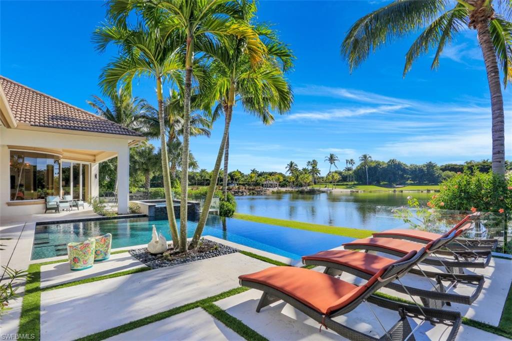 Enjoy spectacular 180-degree water/golf course views from nearly every room. Located on the 6th & 7th hole of the Palm Course, this custom designed home exhibits resort style living at its finest. Renovation was completed in 2011 taking this already spectacular home to the next level. The de Giulio designed chef’s kitchen showcases state of the art appliances including an induction cook-top w/custom painted glass backsplash & German custom cabinetry. Other highlights included a new impact door & window package, motorized solar shades, custom closet systems, de Giulio design master bathroom, library w/special cabinetry features, over-sized gutters, new landscape package w/Zoysia grass & exotic flowers that attract butterflies & birds, interior & exterior accent lighting system & a 500-gallon propane tank. Home is finished w/a resort-style pool & spa that are perfect for entertaining. Grey Oaks Country Club offers a lagoon beach style pool, indoor & outdoor restaurant & bar, tennis center, golf facility & state-of-the-art wellness center. Ideally located just minutes to 5th Avenue South's world-class shopping, fine dining, entertainment & white-sand beaches.
