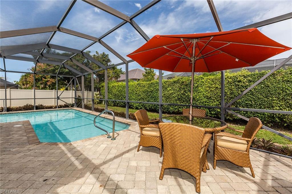 Recently updated with a coastal contemporary flair, this 3 bedroom/ 2 bath residence has 1,600+ sq ft with open floor plan. Main living area has cathedral ceilings with lovely exposed beams and diagonal tile throughout. Kitchen equipped with stainless steel appliances, white cabinets, grey/white natural stone backsplash & granite countertop peninsula breakfast bar. Master suite features plank tile flooring, electric fireplace with barn door entry to an updated bath with porcelain shower with natural stone floor. 2 sets of sliding glass doors open from family room to large lanai with pavers & screened cage enclosing free form heated pool & spa. Back yard offers much privacy with fencing & tall ficus hedge or enjoy gorgeous sunsets from the screened front porch sitting area niche. New roof in 2019, tankless hot water heater, stainless steel washer & dryer, built in cabinetry, guest rooms with bamboo flooring, updated guest bath, AHS home warranty & side shed adds storage, fruit tree and more. Only 1.5 miles to the beach! To view all photos click VT at top of listing for tour!