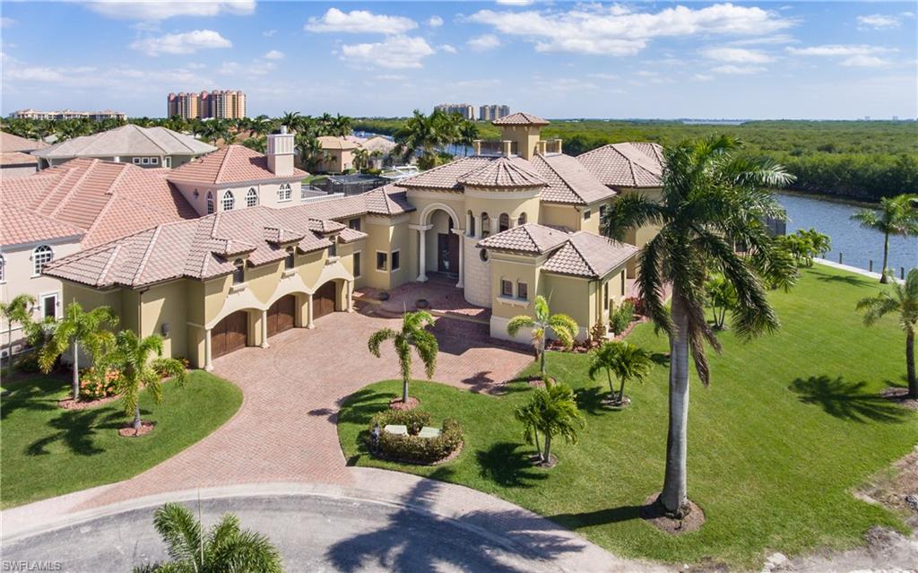 Your dream home has finally hit the market! This elegant and exquisite home displays master craftsmanship & incredible professional decorating in every inch of this almost 6,500+ sq ft  masterpiece, get ready to be WOWED! Located in the prestigious gated community of Cape Harbour, you will experience and feel nothing but pure luxury when you enter the gates and pull up to your driveway. Inside you will find 5 bedrooms, 5 full baths, 2 half baths, soaring ceilings, wood & travertine floors, custom cabinetry throughout, high end stainless steel appliances, formal dining room, central lighting controls, elevator, wine cellar, and many different areas to host and entertain your guests. Outside, is exactly why you are living in SWFL! With a resort style pool, fire pit area, outdoor kitchen, an observation deck, or hop on your boat and head out for a day and enjoy the beautiful beaches. Too many amazing features in this home to mention, you need to see it to take it all in. Located just steps from fine dining, live entertainment, shopping you will wonder why you didn't live here before. Schedule your showing today and don't miss out on this incredible opportunity.