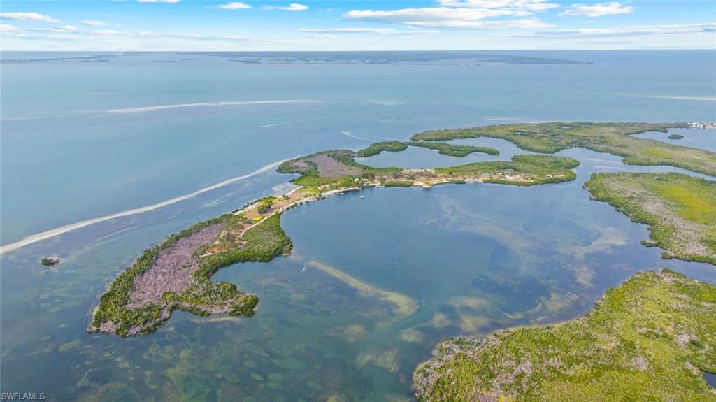 Burgess Island is one of Florida’s most significant private island estates, conveniently positioned in Pine Island Sound between Sarasota and Naples. Spanning approximately 104 acres with extensive shoreline and unmatched privacy, the property presents an extraordinary opportunity for a singular private family compound, a corporate retreat, or an exclusive development, with its 29 developable lots. Centered around an updated 1920s Mizner-style residence, the island is complemented by four charming guest cottages, a clubhouse and pool, and a dedicated property manager’s cottage. There are a total of 11 bedrooms, 10 full and 3 half bathrooms across the island. Lifestyle amenities are equally compelling, featuring a private 9-hole golf course, a pickleball, tennis, and basketball sport court, along with four separate docks providing convenient water access. A helipad enhances accessibility, allowing seamless travel to and from the mainland. The level of infrastructure is rarely found in island offerings of this scale, including mainland power service, four onsite generators, and a reverse osmosis water system - providing both comfort and self-sufficiency. The property’s heritage is as remarkable as its physical attributes. Originally acquired in 1924 by renowned inventor and electrochemist Charles Frederick Burgess - a pioneer in dry-cell battery technology - the island has long been a destination for innovation and distinguished company. Thomas Edison himself visited and planted banyan trees that endure today as living landmarks of this legacy. Comprehensive amenities, flexible access, a convenient yet private location, and a storied past converge to make Burgess Island not merely a residence, but a rare and irreplaceable asset. Ideally positioned for the Southwest Florida lifestyle, the island offers immediate access to world-class tarpon fishing, exceptional boating, and kayaking through pristine waters, while remaining just moments from the historic Gasparilla Inn and championship golf. From your dock, cruise to Cabbage Key for a relaxed waterfront lunch or continue on to Boca Grande for an evening of dining and coastal charm—where nearby islands and waterways naturally extend the experience beyond the property. Located ~6 mi. to Gasparilla Inn & Golf Club, ~2 mi. Useppa Island, ~1 mi. to Four Winds Marina, ~5.5 mi. to Boca Grande Marina (Miller’s), ~11 mi. to Coral Creek Airport & Golf Club, ~19 mi. to Punta Gorda Airport (PGD), ~28 mi. to RSW, and ~45 mi. to Naples Airport (APF). The island is known as Little Bokeelia Island, Burgess Island, and Pentecost Island.