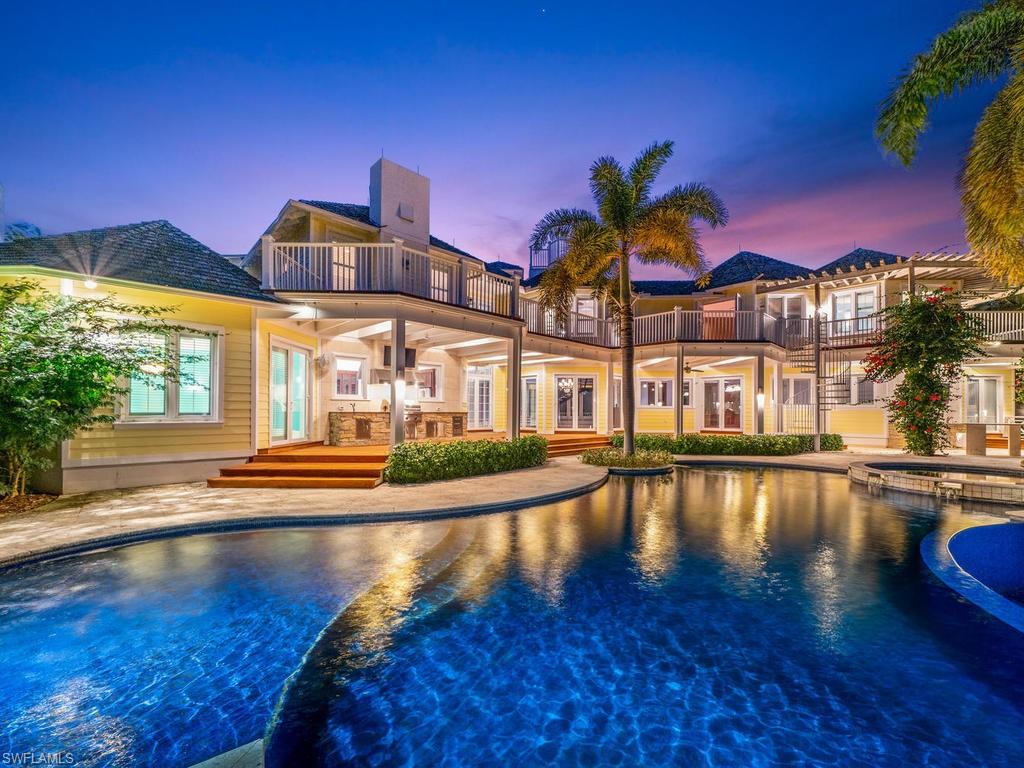 This exquisite lakefront estate, located in Port Royal, is among the premier properties in the southwest Florida. Situated on a cul-de-sac lot and spread over nearly 7,500 square feet, there is plenty of space for entertainment, as well as 5 oversized bedrooms plus a den/office, a game room, loft area, and 7 and 1 half bathrooms. With views of the lake in nearly every room, there are upgrades worthy of this fine property that include high-end kitchen appliances, granite countertops, a large center island and walk-in pantry, extensive wood work and ceiling details, cherry hardwood floors, custom cabinets, built-in closets throughout, an elevator with access to a private rooftop terrace, lighting automation, a wet bar with a 10,000 bottle wine cellar, a 4-car garage, a home generator, and a score of other additions. The lanai features custom design around the large heated infinity edge pool and spa, several sun-deck areas, a gazebo, outdoor kitchen, lush landscaping, and views of the lake and island preserve beyond. This is a one-of-a-kind estate that is an absolute for the confident buyer. Port Royal Membership available.  Best price newer home in Port Royal by over $2m. Call today!