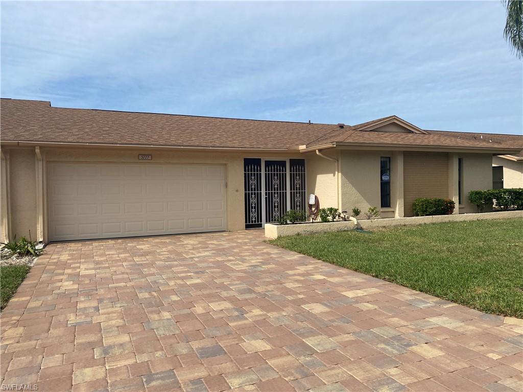WHISKEY CREEK 2 BR 2 BA 2 car gar VILLA. Western rear exposure with expansive 4 season lanai. AC AUG 2014. Electric storm shutters provide safety and protect most windows plus lanai has manual storm shutters. Garage door 2018. Roomy 1442 sq. ft. of living area under air. Paver brick driveway. Newer front gate opens to enclosed entry area. Master with oodles of closet space & ensuite full bath and dual sinks. Features formal dining room, large family/living room, inside laundry room, and breakfast area. Kitchen has desk area, blond cabinets and CORIAN solid surface counters. Tile floors in kitchen. Carpet in living and bedroom areas. Large glass sliders open into an expansive 30 ft. lanai with beautiful view of the pool/Ramada area. Largest common area in all of Whiskey Creek Village Green with a walking trail. Heated community pool area within steps from your back door. Close to Whiskey Creek C.C., dining, entertainment, worship, shopping & beaches. Basic cable, insurance, outside maintenance, landscaping and roof is included in $400/monthly condo fees! Your pet under 20# welcome. Desirable Section 14 condo assn - good reserves. One of last WC villas, built in 1984. 55+ community.