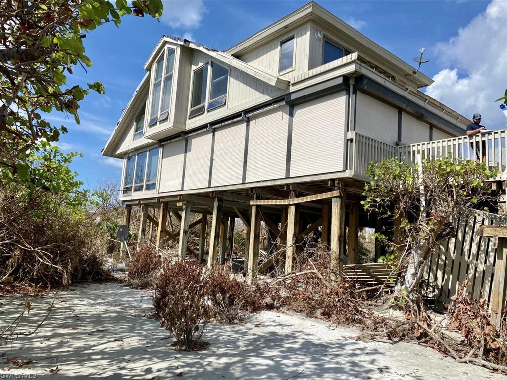 This home did have significant damage from Hurricane Ian to the property and the home.  Noticeable damage includes uprooted trees, damage to the roof, damage to the pool and equipment. stairs were washed away and railing damaged, the garage was demolished, air conditioning units washed away and some damage to interior ceilings and floors occurred in addition to possible unknowns. Once repaired, this magnificent beachfront beauty on Sanibel Island will once again be the epitome of luxury beach home!  This beautiful home is being offered furnished and turnkey.  From the moment you enter this home you will notice the impeccable decor, quality in construction and pride of ownership. With designer furnishings throughout and over 3600 square feet, your guests will appreciate their own dedicated guest house with 2 bedrooms and 2 bathrooms and private laundry.  This home has been meticulously maintained as a family treasure for years and it shows!