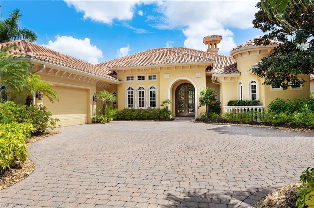 Welcome to this custom 3-bedroom + den, 3.5-bath residence in Chapel Ridge, set on an expansive lot on one of the highest elevations within prestigious West Bay Club. This spectacular home is perfectly designed for both comfort and entertaining. A grand double-door entry leads into a light-filled foyer with soaring ceilings and tile flooring throughout the main living areas, while wood flooring enhances the bedrooms and spacious den. The formal dining room features built-in cabinetry for storage, and a convenient half bath is located just off the entry. The kitchen is the centerpiece of the home with a large curved bar providing ample seating, a center island with rich brown cabinetry that contrasts with the light cream wood cabinets throughout, stainless steel appliances, gas cooktop with hood, and a generous walk-in pantry with built-ins, all complemented by a bright breakfast nook overlooking the outdoor living space. The primary suite offers wood flooring, tray ceiling with soft ambient cove lighting, sliding glass doors to the lanai, two large custom walk-in closets, and an oversized bath with dual vanities, a soaking tub, and a spacious walk-in shower, enhanced by an additional tankless water heater dedicated to the master bath. Both guest suites include wood flooring, large closets, and private access to a separate side patio with pergola, while the two full guest baths feature granite countertops, with one offering a walk-in shower and the other a tub/shower combination. Additional highlights include a large laundry room with built-in cabinetry, sink, and countertop space, a tankless water heater and whole-house generator both powered by natural gas, a built-in entertainment system, LED dimmable ceiling lights throughout with remote control capability, and a three-car garage. Outdoor living is exceptional with a screened lanai offering covered and open seating areas, a resort-style L-shaped pool featuring a water fountain backdrop and hot tub that cascades into the pool, an outdoor kitchen with grill and refrigerator, and a cozy outdoor fireplace, all overlooking a spacious fenced backyard. Residents of West Bay Club enjoy a private Gulf-front Beach Club with full restaurant and bar, chair and towel service, and 200 feet of direct beach access. The newly renovated Bay House features a resort-style pool, yoga and Pilates studios, spinning and stretching rooms, sauna, Aqua Café for indoor or poolside dining, eight clay tennis courts, and a state-of-the-art Technogym fitness center. River Park offers Estero River access with a boat launch and Gulf access, boat storage, kayaks and canoes, a fishing pier, playground, picnic areas, basketball court, and a scenic 1.5-mile walking trail. The Sports Park includes six pickleball courts, bocce courts, a fitness lawn, and two separate dog parks. Optional memberships are available for the private 18-hole Pete and P.B. Dye championship golf course and clubhouse.