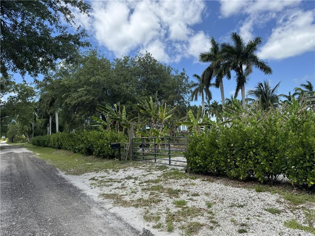 Build your island estate home on this secluded five-acre homesite located in Bokeelia on beautiful Pine Island and enjoy island living at its finest.  The entire property has been elevated and has a homesite pad and an out-building pad elevated to FEMA specifications.  There is a 70' X 30' building under construction on this pad which will be completed by the seller.   Both pads overlook a large aeriated pond stocked with fish and surrounded by Royal Palms.  An additional large pavilion on the property accommodates a 60,000Kw solar system with solar panels on the roof and below in a climate-controlled shipping container is the battery bank, a laundry and a bath.  The solar system is capable of providing all the power requirements of the property and a proposed three bed, two bath home with power to spare.  Also, there are three RV hook ups at the pavilion. The plantings on the property have a drip irrigation system.  Don't miss this opportunity to acquire this truly unique and self-sufficient property with all the infrastructure in place.  Owner will consider financing.