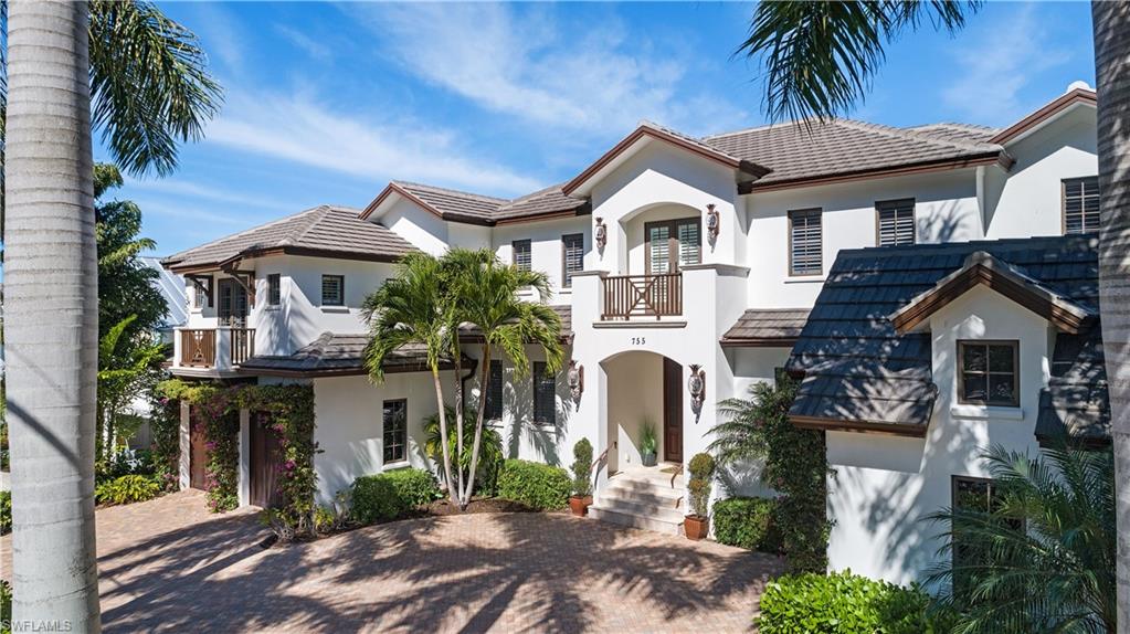 This exquisite five bedroom/six bathroom home is full of meticulous details. Hardwood maple, marble tile floors, granite countertops, crown molding, pan ceilings and gas fireplaces are only a few of the deluxe features. The first floor has a master suite with two walk-in closets and a luxurious spa bath. A formal dining room, home office, sitting room, and large laundry room add to the impressive first floor layout. The family room with wet bar is located off the kitchen. The kitchen boasts stainless steel Viking, Sub-Zero, and Bosch appliances. The second floor has three en suite bedrooms, a family room, small kitchen and large wrap around balcony. The fifth en suite bedroom is located on its own private landing. The home has a two-car attached garage and a separate one-car attached garage. Private boat dock with easy access to the Gulf. The landscaping and private pool and spa lend to the relaxing outdoor atmosphere. Cooking al fresco on the outdoor grill or sitting on the dock to fish are some of the enjoyable pastimes offered here. Only a short walk to the beach, historic 3rd Street South and 5th Ave South down a street lined with Royal Palms, this beautiful home can’t be beat.
