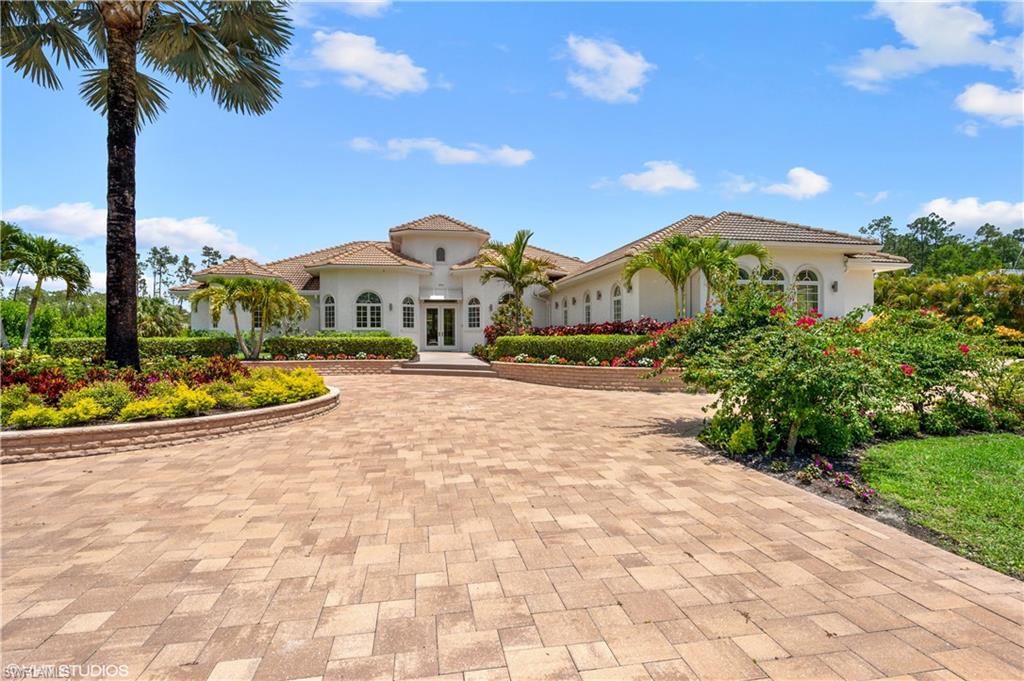 A luxurious home in the Logan Woods area includes a Smart home, with crown molding, gas fireplace, impact glass, a long driveway, and custom California closets to mention some of the magnificent upgrades. This is a custom-built home with a specially formulated super brick (Aercon) that is fireproof, bulletproof, pest-resistant, and hurricane-proof. You will enjoy growing your own spices and vegetables outside your lanai. Perfect for entertaining, the lanai features A/C, a massive screen that encloses a custom pool and spa, a brand new outdoor kitchen, and a manicured garden with no noise from pumps or machinery. If you are a golfer get ready to practice in your own Putting Green in the backyard. Enjoy endless meals inside your chef's kitchen with Wolf and Sub-zero appliances, porcelain tile floors, and a reverse osmosis water system. The master suite has access to the lanai with dual vanities, tub, Toto Toilet, and shower.  Conveniently located in the center of North Naples close to upscale shopping, fine dining, & the best cultural events that SWFL has to offer. Don't miss this opportunity to live a peaceful and active lifestyle in SW Florida in an ultra-secure home!