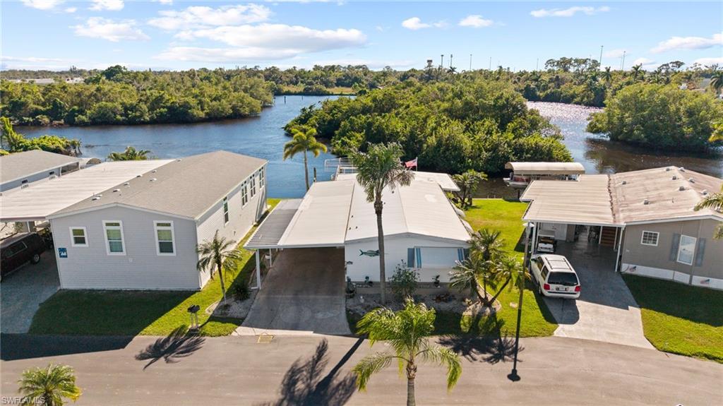 Do you want to see Manatee outside your backyard? This spectacular remodeled waterfront home could be yours! This home boasts 2 spacious bedrooms and 2 full baths. Featuring almost 1,600 square feet of living area, with new mini splits, appliances, pot filler, flooring, hand crafted interior doors, large dining area, huge master suite, a screened porch that overlooks the river. Also 252 square feet of storage area with an air conditioned workshop, a two-car carport, private dock with a 10,000-pound boat lift, spacious patio, and also furnished. Community amenities include new pickleball courts, bocce ball, shuffle  board, horseshoes, heated pool with clubs and activities, clubhouse and 2 boat ramps. The monthly maintenance fee is $407 which includes professional management, water, sewer, fiber optic Internet, trash and recycle pickup, lawn mowing, private roads. Two animals per household are welcome. Some dog breeds are prohibited, so be sure to review the community rules. ESA or service animals are allowed. All buyers must be approved by management. Orange Harbor is a 55+ waterfront community close to shopping and easy access to restaurants and downtown Fort Myers.