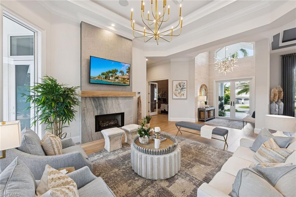 Home is high and dry and never had water - not even in the garage! Sold turnkey furnished - move in today and start enjoying all Aqualane Shores has to offer.  Tucked along a direct Gulf-access canal in prestigious Aqualane Shores, this spectacular estate captures the essence of Naples waterfront living. Offering southern exposure, a new seawall and dock (2023), and a full interior transformation - this home combines timeless coastal design with modern innovation and effortless livability. Designed for those who value refined coastal living, the residence showcases seamless indoor-outdoor flow with a resort-style pool and spa, expansive tiered decking, and an upgraded outdoor kitchen overlooking tranquil water views. Inside, wide-plank oak flooring, soaring ceilings, and elegant millwork create a timeless yet modern aesthetic. The light-filled main level features a grand great room, gourmet chef’s kitchen, and a serene primary suite with direct lanai access, while an additional guest suite provides comfort and privacy. Further highlights include a whole-home generator, upgraded HVAC systems with dehumidifier and garage A/C, new pool equipment, 25,000 lb. boat lift,  and all-new televisions throughout. Enhanced landscaping, a comprehensive alarm and camera system, and meticulous attention to detail, inside and out, ensure the home lives as effortlessly as it looks. Just a short walk from Naples’ world-class beaches and the fine dining and boutiques of Third Street South, this Aqualane Shores home exemplifies luxury waterfront living at its finest.