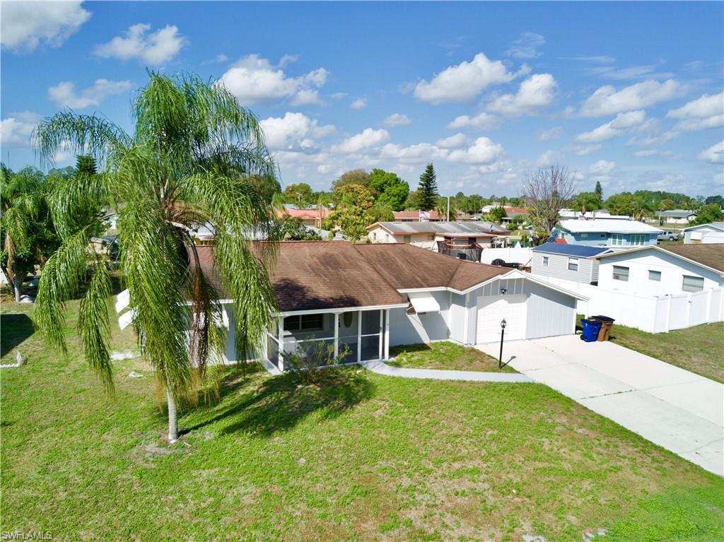 Here is a great opportunity to snatch up a super affordable single family home located in Parkwood, less than a minute from downtown Lehigh! The seller just updated the home with fresh paint inside & out to add a modern paint scheme, new wood plank tile flooring, light fixtures, ceiling fans, bathroom vanities, toilets & re-screening for the lanai and garage area. Inside the bright split floor-plan, you will find an open living room and dining area, classic coat closet and a large hallway closet for linens and extra storage. The galley style kitchen features plenty of cabinet space & a unique garden window for plants that rests over the sink area. The guest bedroom sits right next to the guest bath for private use and the master bedroom features a large walk in closet along and a walk in shower in the master bath. Large den is under central air and would make a great office or play room and there is a laundry room in house, no doing laundry in the garage! City water and sewer, screened front lanai, awning and accordion storm shutters, mature trees and an extra wide driveway that fits up to 6 cars! Don't let it slip through your fingers! Make the call today & make it yours!
