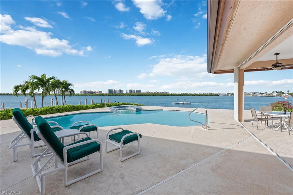 Few properties in Southwest Florida capture the spirit of Marco Island; this original and unique setting sits on a half-acre lot with endless water views of Collier Bay. From your open patio, imagine enjoying the nightly painted sunset sky from the pool, admiring the passing boats coming and going through the 90-foot  canal. Enjoy preparing family meals either in your chef's kitchen or at your built-in outdoor grill. Just under 4,000 square feet, this home boasts many desirable features, such as a three-car garage, first-floor master suite that opens to the patio area, high ceilings and a flexible open floor plan, creating an ideal opportunity for a new owner to add their personal touch. Come and see for yourself why so many people choose to make Marco Island their home.