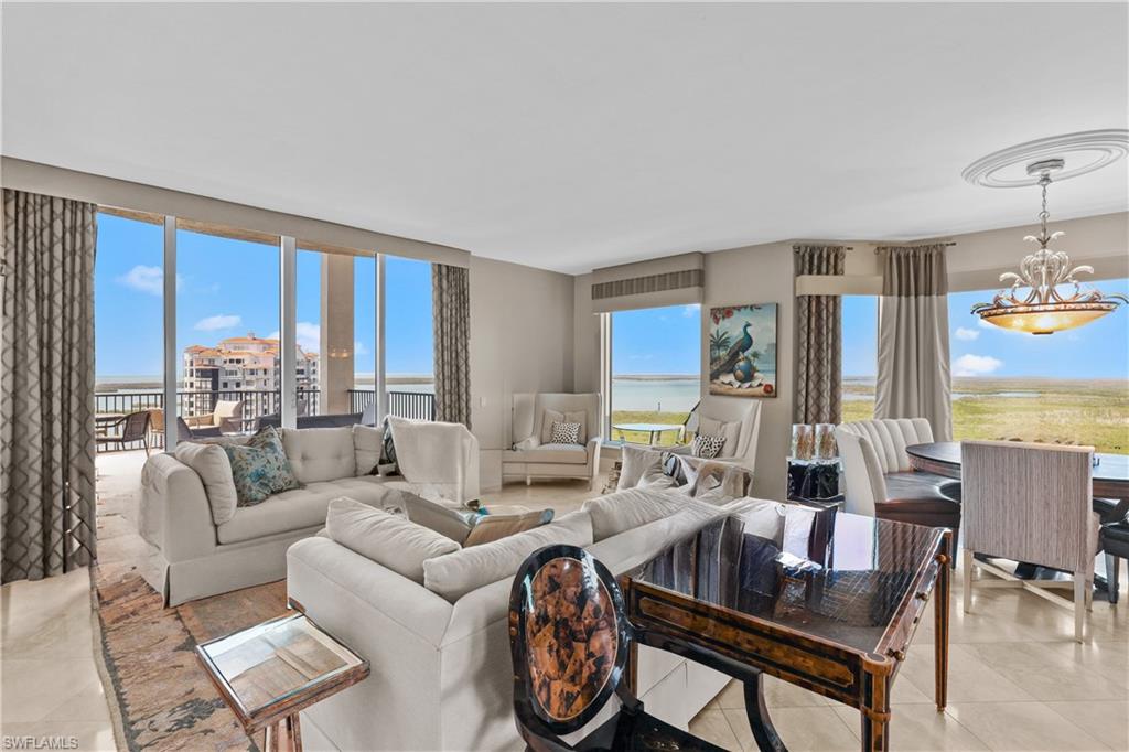 This luxurious two-story penthouse offers sweeping views of Estero Bay and the Gulf of Mexico. Polished marble tile flooring in a beautiful neutral tone creates a luxurious and timeless look. A custom-made curved staircase with wrought iron balusters adds a dramatic touch to the entryway. Soaring windows in the living room with a gas fireplace set the tone for entertaining. Subzero-built-in wine locker with temperature and humidity control to store and age your favorite wines. Top-of-the-line appliances, 6 burner gas range, and center island with additional dishwasher. Custom cabinets in the den, family room, library, upgraded lighting, laundry on both floors, and private enclosed 2-car garage with storage. Your most discerning buyers will fall in love. Palermo has 2 guest suites, a theater, billiards, a pool/spa, a BBQ pavilion, a fitness center, front desk staff, and an on-site building manager. Residents of The Colony enjoy private membership to a waterfront dining facility, The Bay Club, with exceptional views with sunset dining/entertainment. Experience a full array of amenities such as kayaking, canoeing, sailing, bocce, tennis, pickleball, and the private beach park accessed by water taxi. 15 minutes to the airport.