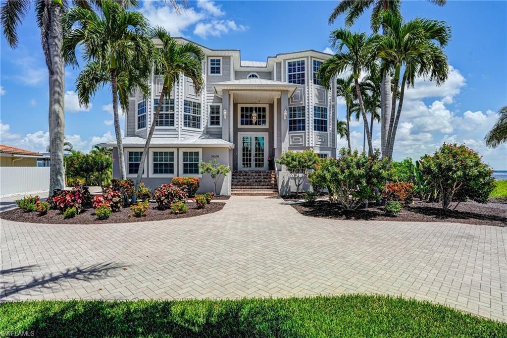 Luxury Bayfront Estate | Expansive Bay Views & Resort-Style Living! Imagine waking up each morning to panoramic 180° Bay Views, where the sun rises gracefully over the bay and sets in a blaze of color on the horizon. 30,000 lb Synergy Boatlift, 5 ensuites, elevator, 3+ car garage. Nearly every room in this home captures breathtaking views, immersing you in the beauty of coastal living. After sunset, retreat to the dock, the lanai, or your private master deck to watch the stars emerge—on a clear night, hundreds sparkle above, and you may even glimpse rockets launching from Cape Canaveral. The soothing sound of the distant ocean waves completes the picture of tranquility. The newly remodeled heated saltwater pool and spa create your own private resort. Relax with music or a favorite show on the lanai’s large-screen TV, or gather for a cozy movie night under the stars. With five spacious en-suite bedrooms, the home provides ultimate privacy and comfort for family and guests alike. The open-concept kitchen and dining areas accommodate up to 14, making it perfect for entertaining on any scale. Every detail of this residence is designed for both luxury and function. A 3+ car garage with a newly finished multi-coat polyurea floor offers abundant storage, while numerous large closets ensure everything has its place. Beyond the home, the lush landscape is adorned with fragrant flowering plants and stately palms, creating a true tropical retreat. For the boating enthusiast, the private dock system is unparalleled. Outfitted with a 30,000 lb. Synergy boat lift and new boathouse roof, a double IMM Quality PWC lift and 50-amp shore power, it has been fully re-decked with premium AZEK materials for durability and style. Launch your kayak or paddleboard from the floating EZ Dock and explore mangrove islands teeming with dolphins, manatees, stingrays, & native birds—even the occasional bald eagle. Quick Gulf access means you can reach Big Carlos Pass in about 12 minutes, enjoy a trip to Naples or Marco Island in just over an hour, or head north for a scenic ride to Cabbage Key. At home, cast a line off the dock for snapper or sheepshead while enjoying the evening migration of ibis or the sight of dolphins gliding by. This smartly equipped residence ensures modern comfort with high-speed mesh Wi-Fi extending throughout the home, pool deck, and dock. Even while aboard your boat, you can stream video seamlessly. Smart Leviton lighting controls, newer appliances—including GE Profile washer/dryer, KitchenAid dishwasher, and microwave/convection combo—and thoughtfully included furnishings (7 TVs and more) make this property move-in ready. With deeded neighborhood beach access just a 15-minute stroll away, you’ll also enjoy daily sunset gatherings with neighbors on the white sands of the Gulf. This home is more than a residence—it’s an experience of refined coastal living, where every sunrise, sunset, and starry night is yours to savor.