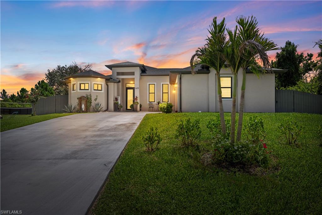 Situated on a spacious half-acre lot in the highly desirable Sunshine neighborhood of Lehigh Acres, this beautifully maintained 3-bedroom, 2-bathroom home with a den offers the perfect blend of space, comfort, and functionality. The versatile den features a closet, making it ideal as a home office, guest room, or potential fourth bedroom. The spacious primary suite serves as a private retreat, complete with dual vanities, a relaxing soaking tub, a separate walk-in shower, and a generous walk-in closet. Enjoy peace of mind with a reverse osmosis water system, irrigation system, gutters surrounding the entire home, and a fully fenced backyard with fencing on three sides of the property, offering privacy and plenty of room for pets, entertaining, or future additions. The oversized garage is equipped with a mini-split air conditioning system, making it ideal for a workshop, home gym, or additional storage. Step outside to a covered lanai and extended concrete patio, perfect for enjoying Florida's outdoor lifestyle. Conveniently located near Sunshine Boulevard with easy access to shopping, dining, schools, and Fort Myers, this move-in-ready home offers the space, upgrades, and location today's buyers are looking for.