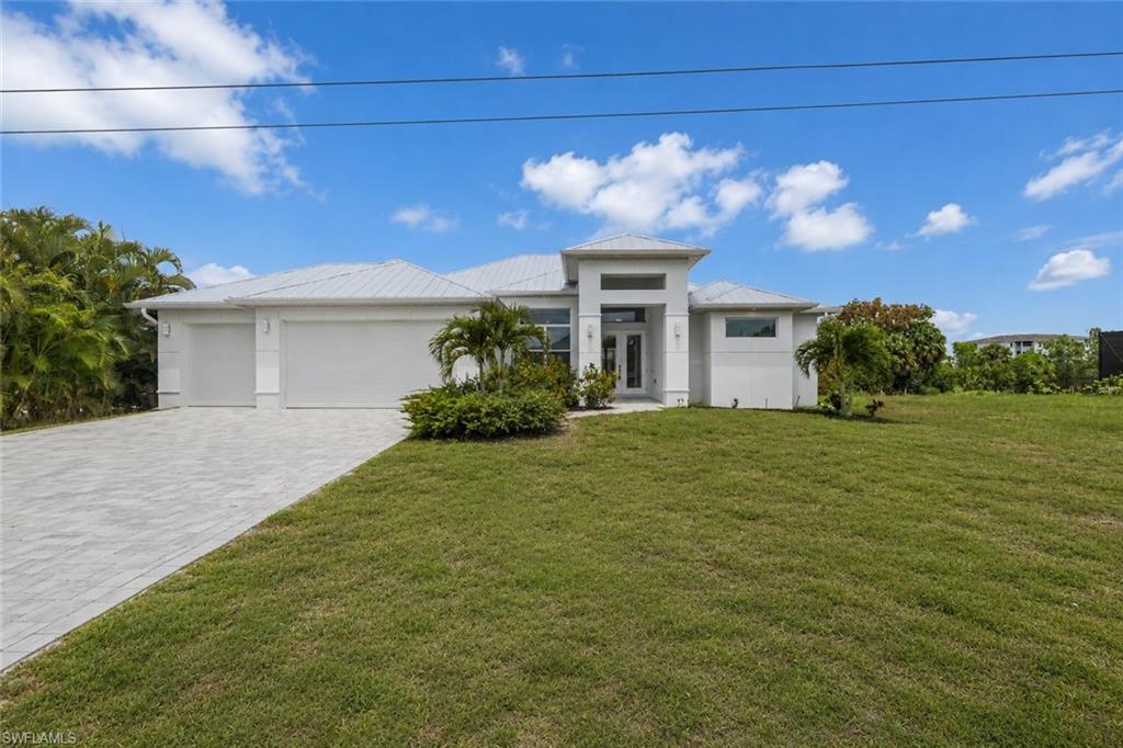 Built in 2023 and located in one of the most desirable areas of Southwest Cape Coral, this Gulf Access residence offers the perfect blend of luxury, safety, and modern coastal design. Featuring 3 bedrooms plus a den, 2 bathrooms, and a 3-car garage, every detail of this home was thoughtfully designed with quality craftsmanship and upscale finishes throughout.

The gourmet kitchen serves as the heart of the home, showcasing granite countertops, a custom tile backsplash, two-tone custom cabinetry, stainless steel appliances, and a spacious layout overlooking the great room with soaring ceilings. Expansive 90-degree impact glass pocketing doors completely disappear into the wall, seamlessly connecting indoor and outdoor living spaces and creating the true Southwest Florida lifestyle buyers dream about.

Step outside to the large under-truss lanai, designed for entertaining family and friends while enjoying beautiful waterfront views. The vented summer kitchen with stainless steel appliances overlooks the pool and canal, making outdoor gatherings effortless year-round.

The luxurious owner's suite features two custom walk-in closets, dual vanities, a walk-in shower, and a relaxing soaking tub. A private den with glass barn doors provides the perfect home office while allowing natural light to flow throughout the space. Crown molding, tray ceilings, and elevated trim work add elegance and sophistication throughout the home.

Additional features include a metal roof for enhanced storm protection and potential insurance savings, impact-resistant windows and doors, a 3-car garage with epoxy flooring, and city water and sewer assessments that are fully paid.

The guest bathroom conveniently serves as a pool bath with direct access to the lanai, helping keep wet feet out of the main living areas. Outside, the seawall is complemented by a cantilever dock, creating a comfortable waterfront seating area to relax and enjoy the peaceful canal views.

This exceptional Gulf Access home combines modern luxury, quality construction, and the waterfront lifestyle that makes Southwest Florida one of the most sought-after places to live.