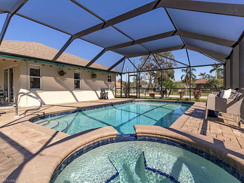 H.14086 - Live in walking distance to two world class beaches and take a 5 minute drive to a third. Life is good in this 3 bedroom, 2 bath, home with a formal living, formal dining, dinette and family room.  Southern exposure lanai is 2300 square feet with (under ground propane) heated pool and spa and a brand new super-screen enclosure. Spacious under cover sitting area and full pocket doors extends your living space to enjoy the coastal life.  Large corner lot with fenced in area surrounding the lanai with room for an RV/boat storage.  Bonita Shores is a boating community with a community boat launch and fast water access to the bay.  Located in Collier County, Bonita Shores is a beautiful neighborhood with no HOA fees and a short walk to several local restaurants and shops!