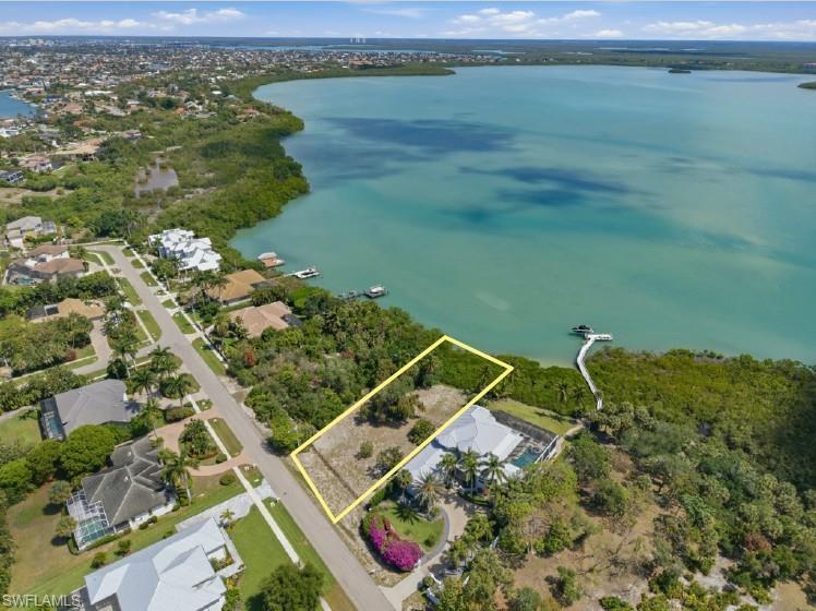 Build your piece of paradise on this exceptional waterfront homesite, ideally positioned on the west side of Caxambas Drive.  Offering a premier setting to embrace Marco Island's coastal lifestyle, this property showcases expansive bay views and a picturesque backdrop of nearby islands with a high elevation (no need for flood insurance).   Enjoy a dynamic waterfront scene filled with passing boats, vibrant sunrises, gentle coastal breezes, and an abundance of birdlife and native wildlife. With ample space to design a custom residence tailored to your vision, this lot presents a rare opportunity to create a private retreat in one of the island's most sought-after areas. Whether you envision a luxurious estate or a relaxed coastal getaway, the setting provides the perfect canvas. Ideally located near beaches, dining, and island amenities, this cleared homesite is ready for construction--offering the perfect blend of tranquility, accessibility, and breathtaking panoramic views as you bring your dream home to life.  The home adjacent to this lot is also being sold separately for an option for your own private estate.