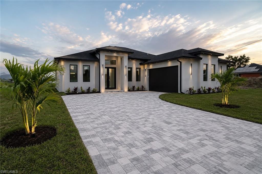 Welcome to this beautifully designed NEW CONSTRUCTION home situated on a freshwater canal in NE Cape Coral. This modern residence offers 3 bedrooms, 3 full bathrooms, and an open-concept floor plan designed for both everyday living and entertaining. Soaring 12.5-foot ceilings, smooth-finish walls, and marble tile flooring throughout create a sophisticated and luxurious feel from the moment you enter.

The spacious living area is filled with natural light from oversized windows, creating a bright and inviting atmosphere. The European-inspired kitchen features sleek white cabinetry, stainless steel appliances, matte black fixtures, a large center island with seating, and ample storage. Adjacent to the kitchen is a dedicated dining area with space for a coffee station or breakfast bar.

A versatile flex space provides the perfect opportunity for a home office, playroom, or additional sitting area. The walk-in pantry offers generous storage, while the interior laundry room includes convenient access to the HVAC utility closet for simplified maintenance.

The spacious primary suite offers a private retreat complete with dual walk-in closets and a linen closet. All three full bathrooms feature modern finishes designed to complement the home's contemporary style.

Additional features include impact-resistant windows and doors, an epoxy-coated 2-car garage, and a utility wash station ideal for pets, gardening equipment, or cleaning projects.

Exterior features include a fully paved driveway, professional landscaping, architectural lighting, and freshwater canal frontage. Enjoy fishing, kayaking, and peaceful waterfront living right from your backyard. Conveniently located near shopping, dining, schools, and major roadways, this home combines modern design, functionality, and an exceptional Florida lifestyle.

This exceptional property offers the perfect blend of LUXURY finishes, practical living spaces, and waterfront serenity in one of Cape Coral's fastest-growing areas. Whether you're looking for a primary residence, seasonal retreat, or investment opportunity, this move-in-ready home delivers modern waterfront living at its finest.

Virtual Staging Disclosure: Certain photos may include AI-generated virtual staging. AI technology was used to virtually furnish select spaces to illustrate the home's potential use and design possibilities. Furniture, décor, and other staged items shown are for marketing purposes only and are not included with the sale of the property.