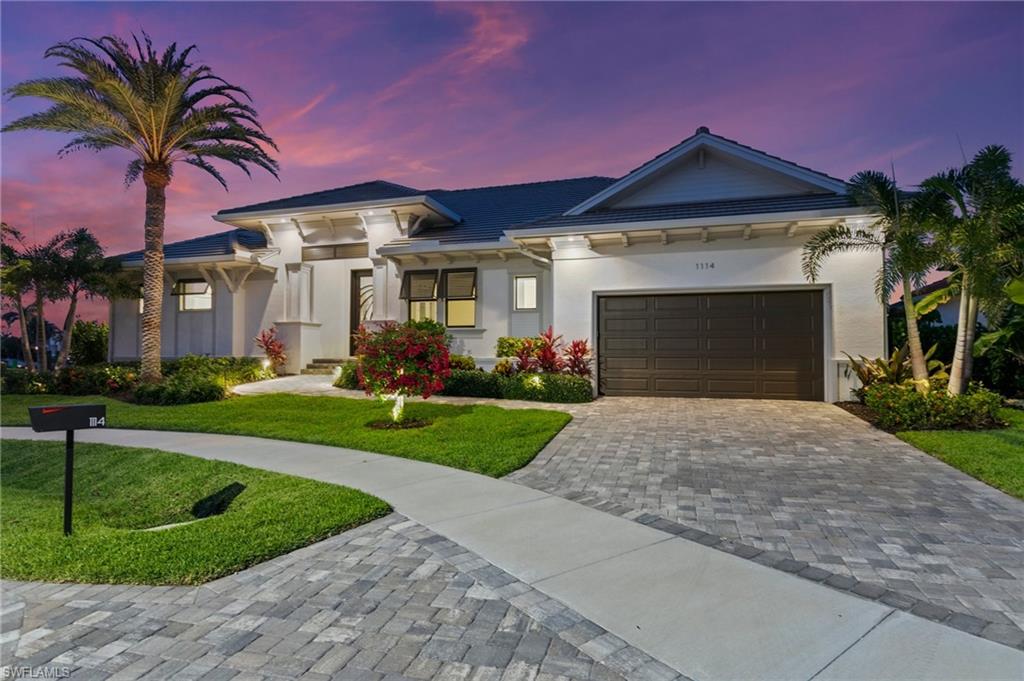 Welcome to this exceptional single-story waterfront residence, situated on a quiet cul-de-sac with beautiful, expansive canal views. This thoughtfully designed home combines elevated style, comfort, and function for the ideal Florida lifestyle, offering four spacious bedrooms, a versatile den, and four full bathrooms. As you step inside, you're greeted by volume ceilings, tray and coffered ceiling designs, and continuous luxury flooring. The open-concept living area is perfect for entertaining, flowing seamlessly into a designer kitchen complete with double ovens, a gas cooktop, and abundant storage—truly a chef’s dream. Find yourself going out onto your expansive picture-window screened lanai, where you'll find a full summer kitchen, a sparkling pool and spa, and a pool bathroom—ideal for hosting or relaxing in your private outdoor oasis. Boating enthusiasts will appreciate the private dock equipped with both boat and jet ski lifts, offering direct canal access for your next adventure on the water. Additional features include impact-resistant doors and windows, modern exterior finishes, tiled wet areas, a 2-car garage, custom closet systems, and a spacious laundry room with built-in cabinetry and a utility sink. Every detail has been considered for both style and convenience. Don't miss this rare opportunity to own a luxurious waterfront home that perfectly captures the essence of Marco Island living.