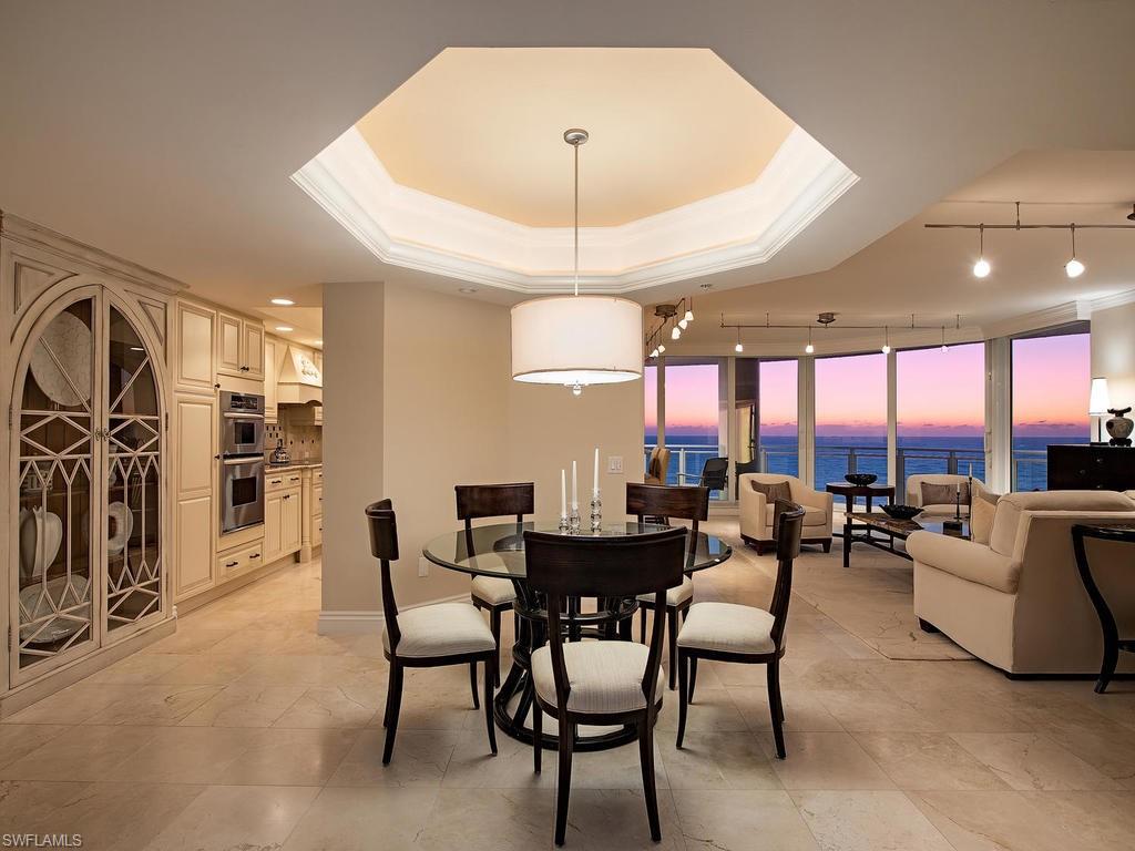 Exquisite views from this spacious beachfront gem. Walk into this gorgeous residence and immediately experience the stunning panoramic aquamarine waters of the Gulf of Mexico, with impact resistant sliding doors & windows throughout. Expansive lanai with unique glass railings offers open air living. A lovely open chef’s kitchen with pass-through views, granite counters, breakfast bar and large prep island give way to sunny views of the white sandy beach. The living and dining rooms are generous with a wet bar and wine cooler for your entertainment pleasure. Beautiful maple wood floors in the den as well as handsome custom cabinetry make this the perfect spot to relax, read a book, or set up as a home office. This modern, sleek building offers many amenities including a 24-hour manned front desk, newly redone fitness center, social rooms, business center, library, pool, spa and guest suites. With the privilege of living in prestigious Bay Colony, you enjoy a secure guard-gated entry, access to a completely remodeled, private Beach Club with a restaurant and state-of-the-art tennis program. Pelican Bay amenities include beach-side restaurants, cabanas & private beaches.