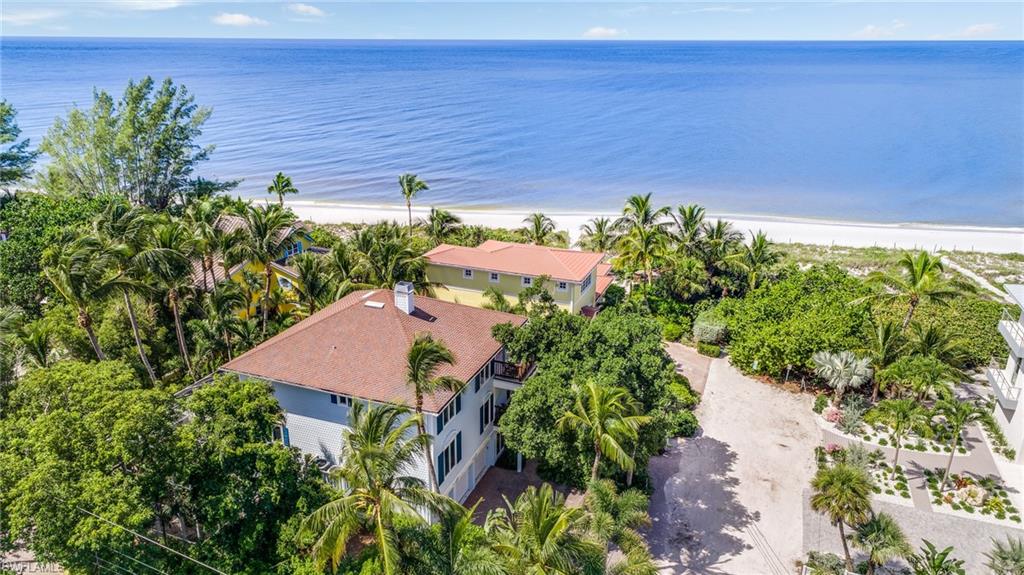 Island living is at its finest from this uniquely charming and stunningly updated home at the end of Captiva’s Wightman Lane. The unique design was thoughtfully conceived to maximize the views of the Gulf and sunsets, which can be enjoyed from the main areas and both large lanais, which are on the top floor. A warm stone fireplace greets you, and stunning wood floors lead you to the large, updated kitchen perfect for entertaining or preparing a delicious meal and past the elevator to the inviting living room. Vaulted ceilings add to the ambiance, and opening the sliding glass doors will bring in the sound of the surf. The second floor has all new wood flooring and features another living room, guest bedrooms and a large master bedroom down the private hall. The master bath has just been gorgeously remodeled with an eye for comfortable luxury. The stunning grotto-style pool and hot tub are surrounded by a large pool cage and tropical privacy, changing room and bar area. This is a Captiva gem.