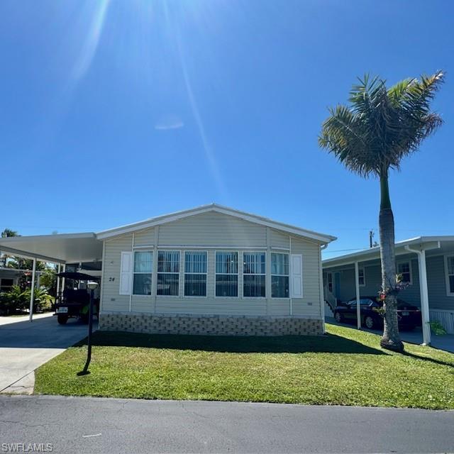 Welcome to 24 Oregon Trail, a well-maintained modular/manufactured home built to FHA requirements, nestled in the desirable community of Naples, FL. This 2-bedroom, 2-bath residence offers approximately 24’ of width and 53’ of length (per title), plus a generously sized shed. The home features a large living room and a versatile kitchen/dining/family room combination, providing ample space for relaxing and entertaining. Carpet runs throughout the home, complementing the cozy atmosphere. Recent upgrades include a new Café-style GE refrigerator (2018), electric range and microwave (2019), garbage disposal (2019), and a new A/C heating unit installed in 2019. A new roof was added in 2018 along with a new carport (2018/2019), and a screened-in lanai (2019) complete with a 5’ mechanical screen door operated by remote control. The large shed, renovated in 2018/2019, houses a 2018 washer and dryer, and a 2019 white refrigerator, all conveniently sheltered under the carport roof. Additional highlights include a 2019 rodent control system, a yard irrigation system, hurricane-proof window shutters, and a new water heater installed in 2021. Step out to the small patio in the back to enjoy the Florida sunshine. This home offers a perfect blend of functionality and comfort, just a short drive from the beautiful beaches, dining, and shopping that Naples is known for.