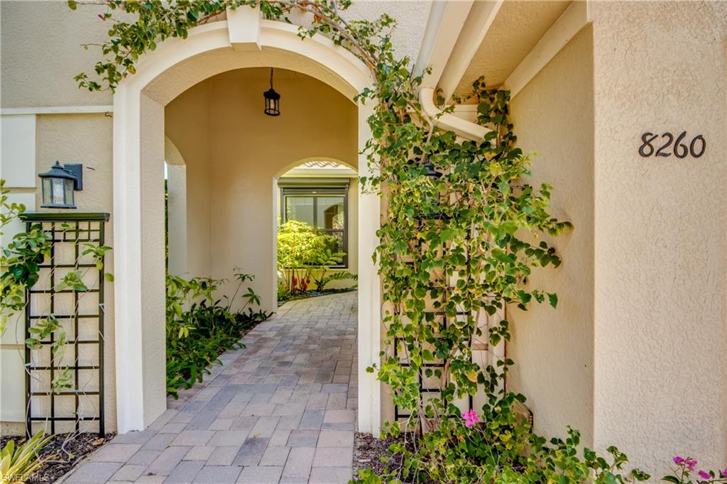 THIS FORMER ZUCKERMAN HOMES MODEL WAS SELECTED TO SHOWCASE THE VERY BEST THE BUILDER HAD TO OFFER IN VENETIAN POINTE. Already appointed with more than $100,000 in premium builder upgrades, the current owners elevated it even further with extensive enhancements including a stunning $120,000 DESIGNER CUSTOM POOL, WHOLE-HOUSE NATURAL GAS GENERATOR, STORM SMART HURRICANE SHUTTERS, CALIFORNIA CLOSETS throughout, professionally designed landscaping and other improvements that enhance beauty, comfort and peace of mind. Even before you step inside, you’ll appreciate what sets this home apart. The inviting front portico, gracefully draped in vibrant bougainvillea and framed by lush tropical landscaping, creates a warm welcome, offering a glimpse of the exceptional attention to detail that continues throughout the home. Inside, timeless elegance meets effortless Florida living. Crown molding, tray ceilings, designer lighting, custom window treatments, custom closets, rich wood and tile flooring and expansive 8-foot sliding glass doors fill the home with warmth and natural light. At the heart of it all is a beautifully appointed kitchen featuring 42-inch soft-close cabinetry, quartz counters, premium stainless steel appliances and a natural gas range. Natural gas also serves the water heater, dryer and whole-house generator, adding efficiency and convenience. Perhaps what you’ll appreciate most is knowing that virtually every meaningful improvement has already been made. A WHOLE-HOUSE NATURAL GAS GENERATOR, STORM SMART ELECTRIC KEVLAR SHUTTERS on sliders, STORM SMART MANUAL ROLL-DOWN SHUTTERS for windows, IMPACT GLASS FRONT DOOR, TILE ROOF and WHOLE-HOUSE SURGE PROTECTION provide exceptional peace of mind, plus PREMIUM GARAGE CABINETRY, ELECTRIC VEHICLE CHARGING and a COMMERCIAL-GRADE EPOXY GARAGE FLOOR. Then there’s the space you’ll likely enjoy most! The spectacular 30’ x 10’ HEATED CUSTOM POOL features a SUN SHELF WITH BUBBLER, THREE ELEGANT WATERFALLS, REMOTE AUTOMATION, CUSTOM LIGHTING, MARBLE PAVER DECKING and a premium NO-SEE-UM SCREEN picture-frame pool cage. Whether you’re looking for a seasonal retreat or a year-round residence, Venetian Pointe, a gated community, makes everyday living REFRESHINGLY SIMPLE. Lawn care, landscaping and irrigation are included, leaving more time to enjoy the community pool, workout room and everything that makes Southwest Florida ONE OF THE COUNTRY’S MOST SOUGHT-AFTER PLACES TO CALL HOME—from NEARBY GULF BEACHES, SANIBEL ISLAND and golf to exceptional shopping, dining, healthcare and RSW International Airport. HIGHLY SOUGHT-AFTER South Fort Myers area. NO CDD. NO FLOODING OR STORM DAMAGE. TRANSFERRABLE flood insurance (ONLY $1,248/yr), if desired. BEAUTIFULLY UPGRADED, meticulously maintained and completely move-in ready, this EXCEPTIONAL former model offers a RARE opportunity to enjoy one of Venetian Pointe’s FINEST VILLAS—where luxury is found not only in the finishes but in the lifestyle they create. STUNNING!