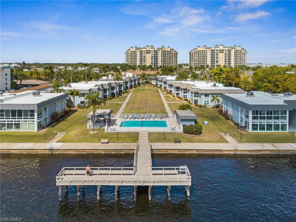 Welcome to Bay Harbor, one of North Fort Myers’ best-kept secrets and a highly desirable 55+ RIVERFRONT community offering incredible views of the Caloosahatchee River and the downtown Fort Myers skyline.

This beautifully updated second-floor 2-bedroom, 2-bath condo is being offered fully furnished, making it truly move-in ready. The second-floor location provides an even better vantage point to enjoy the panoramic river and skyline views while offering added privacy and peace of mind.

Inside, you’ll find a bright and inviting floor plan with luxury vinyl plank flooring throughout, fresh neutral paint, elegant crown molding, and a tastefully updated kitchen featuring granite countertops, white cabinetry, and stainless steel appliances. The spacious primary suite includes a private en-suite bathroom, providing a comfortable retreat at the end of the day.

Recent updates include a new A/C system and electrical panel installed in 2023, along with hurricane-impact windows for added safety and energy efficiency. Bay Harbor has also recently completed brand-new roofs, and there are no outstanding assessments, giving buyers additional confidence and peace of mind.

One of the standout features of this condo is the private lanai, where you can relax with your morning coffee or unwind in the evening while taking in the breathtaking views of the Caloosahatchee River and the downtown Fort Myers skyline. Additional conveniences include a full-size washer and dryer and a rare extra-long one-car private garage with plenty of room for your vehicle plus extra storage for bikes, fishing gear, and beach equipment.

Bay Harbor offers an exceptional lifestyle with amenities that include a large heated waterfront pool, fishing pier, and a welcoming community of friendly residents. Located just minutes from the Fort Myers River District, you’ll enjoy easy access to waterfront restaurants, boutique shopping, art galleries, entertainment, and nightlife. The pedestrian and bike lane across the Caloosahatchee Bridge makes it simple to explore everything downtown Fort Myers has to offer.

Whether you’re looking for a full-time residence or the perfect seasonal retreat, this beautifully updated waterfront condo offers the very best of Southwest Florida living. With spectacular views, outstanding amenities, recent community improvements, and the convenience of being sold fully furnished, this is an opportunity you won’t want to miss.
