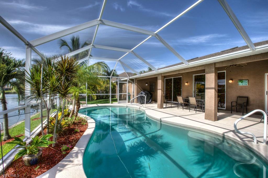 This TURNKEY Gulf Access home is truly a tropical oasis and a boaters dream. Located in the desirable South West Cape Neighborhood, the open concept floor plan with breathtaking water views from almost every room is ideal for entertaining. This home features solid wood cabinets, granite countertops, high end stainless steel appliances, and two large skylights for natural light in the main living areas. The master suite has his and hers sinks, large soaking tub, glass enclosed shower, oversized walk in closet, tray ceiling and sliding doors that open to the lanai. The guest rooms are located on the opposite side of the home, providing privacy. The outdoor living space is just as luxurious with a large under truss screened lanai that provides ample space for grilling or lounging by the heated pool. The lush landscape highlights the expansive water views and leads to the boat dock with a 
13,000 lbs boat lift. The boater in the family will appreciate the short trip to open waters. Come live the Florida 
dream.