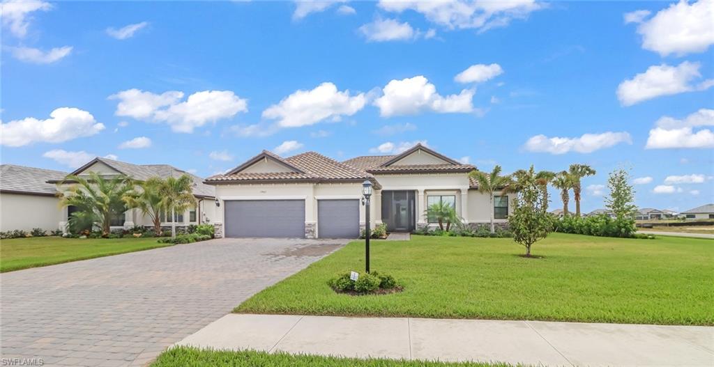 Beautiful oversized corner lot boasting the amazing Oakmont II floor plan perfectly laid out for every day living and entertainment! This home has a 3-car garage, a driveway to fit 9 cars, 3 bedrooms, a flex room, formal dining room, a great room that opens to the lanai with the most desirable Southern rear exposure. The Owners Suite features a private lanai entrance, seating area, and a stunning master bathroom. The kitchen is a chef's dream with an extended island, granite counter tops, custom cabinetry and breakfast nook.  The Place at Corkscrew is a stunning resort-style lifestyle with a zero gravity resort pool, 100' waterslide, two waterfalls, a 40-person spa, splashpad, firepit, restaurant and café, poolside food and beverage service, adult only bourbon bar, dog park, tennis, pickleball, basketball, bocce ball, and so much more. Come experience The Place at Corkscrew and live where others vacation!! Close to RSW Intl Airport, dining, entertainment and the beautiful Southwest Florida beaches.